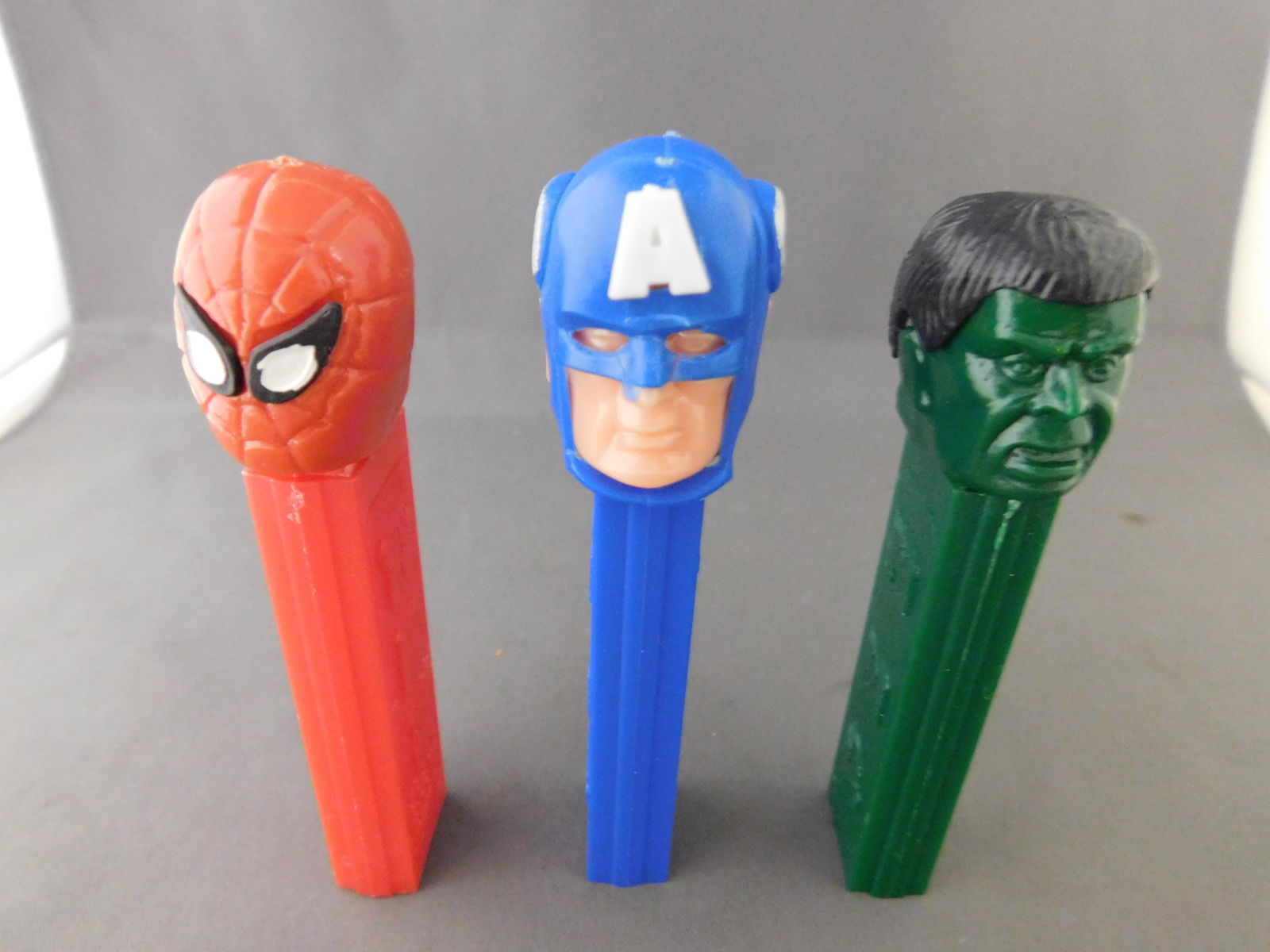 Vintage Super Heroes Pez Lot of 3: Super Heroes Pez Lot of 3. They all have no feet. Included in this lot are Hulk and Spiderman made in Hong Kong and Captain America made in Austria. You are bidding at a live sale, please read the ter