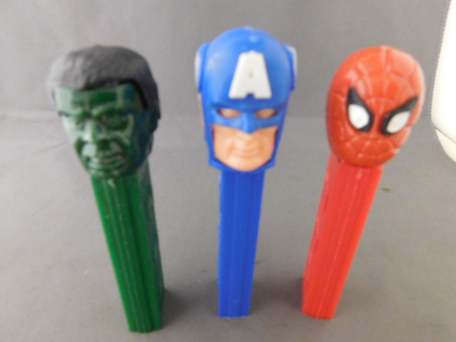 Vintage Super Heroes Pez Lot of 3: Super Heroes Pez Lot of 3. They all have no feet. Included in this lot are Hulk and Spiderman made in Hong Kong and Captain America made in Austria. You are bidding at a live sale, please read the ter