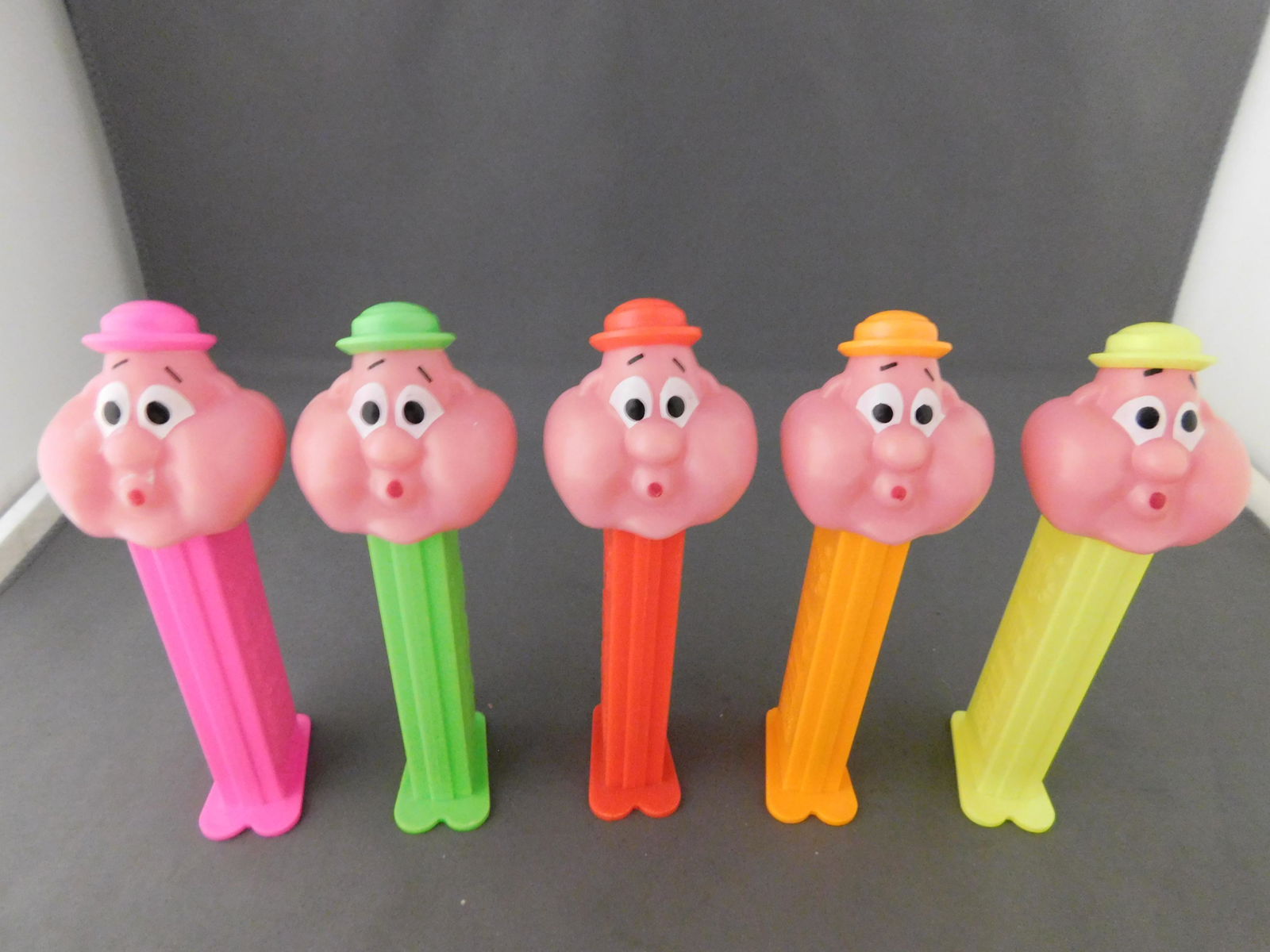 Bubblemen Pez Lot of 5: Lot of 5 Bubblemen Pez with Feet. Yellow, Green, Orange, Pink, and Red Bodies. You are bidding at a live sale, please read the terms and conditions. We are offering contact-less pick ups at our South
