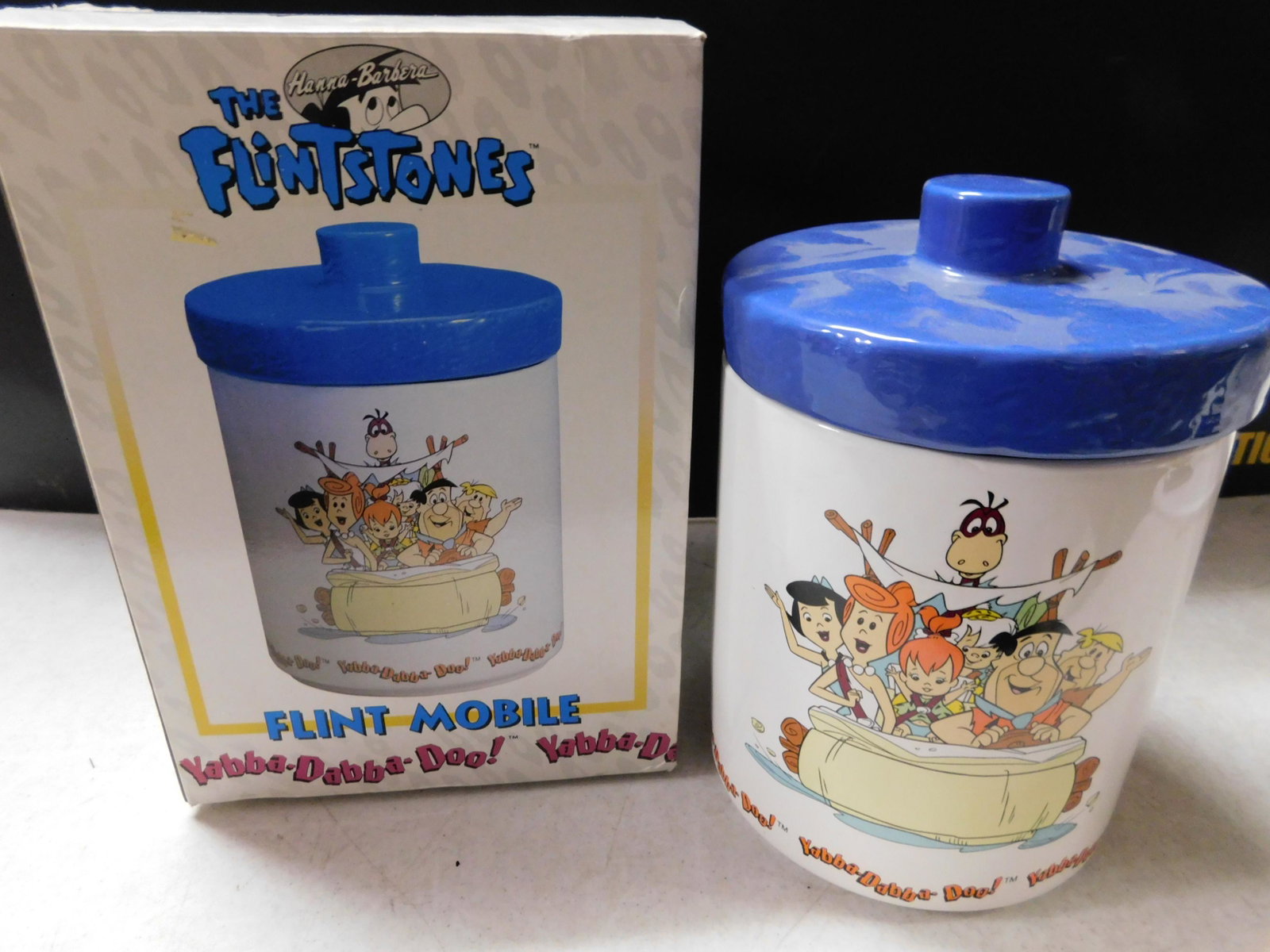 Flintstones Flint Mobile Cookie Jar: The Flintstones Flint Mobile Cookie Jar. Comes with Box. Measures approx. 9.5" tall. You are bidding at a live sale, please read the terms and conditions. We are offering contact-less pick ups at our 