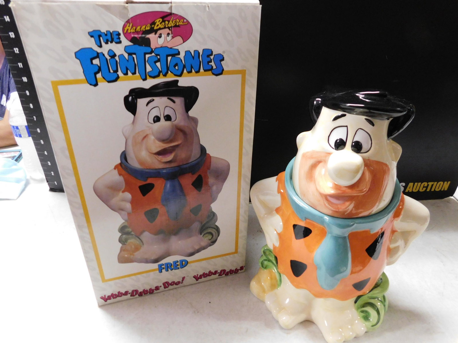 Fred Flintstone Cookie Jar: The Flintstones Fred Flintstone Cookie Jar. Comes with Box. Measures 12" tall. You are bidding at a live sale, please read the terms and conditions. We are offering contact-less pick ups at our South 