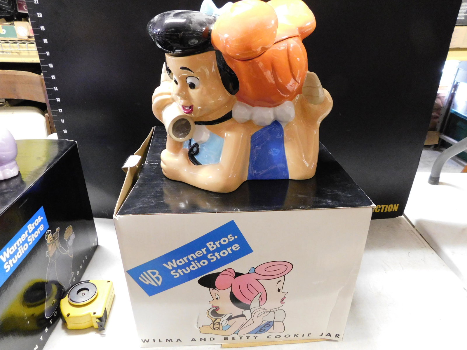 Wilma and Betty Cookie Jar: Wilma and Betty with Telephone Cookie Jar . Warner Bros Studios 1999. Comes with Box. Measures 10.5" tall. You are bidding at a live sale, please read the terms and conditions. We are offering contact