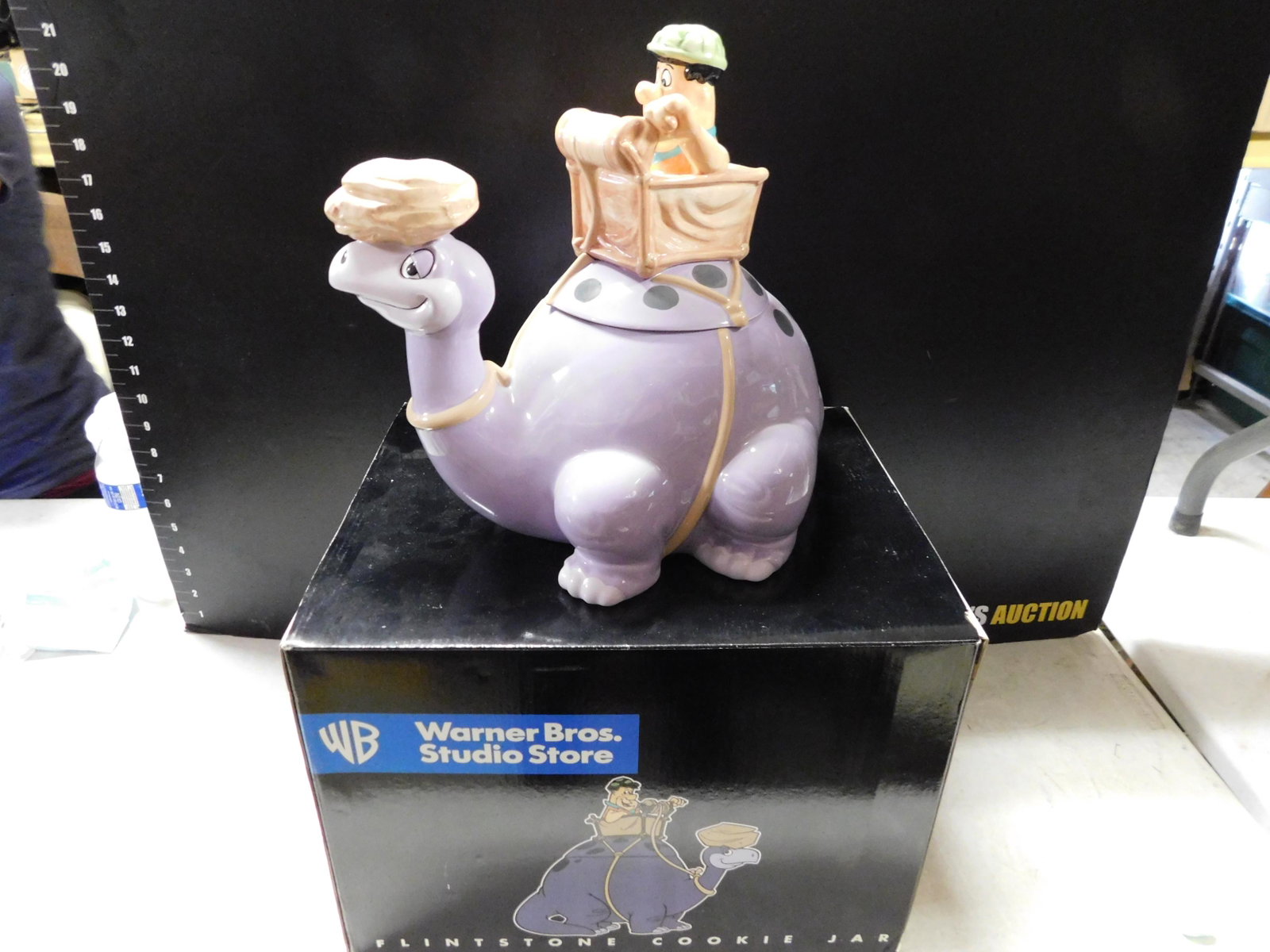 Dino and Fred Flintstone Cookie Jar: Dino and Fred Flintstone Cookie Jar. Warner Bros Studio Store 1997. Comes with Box. Measures 12" High x 13" Wide. You are bidding at a live sale, please read the terms and conditions. We are offering 