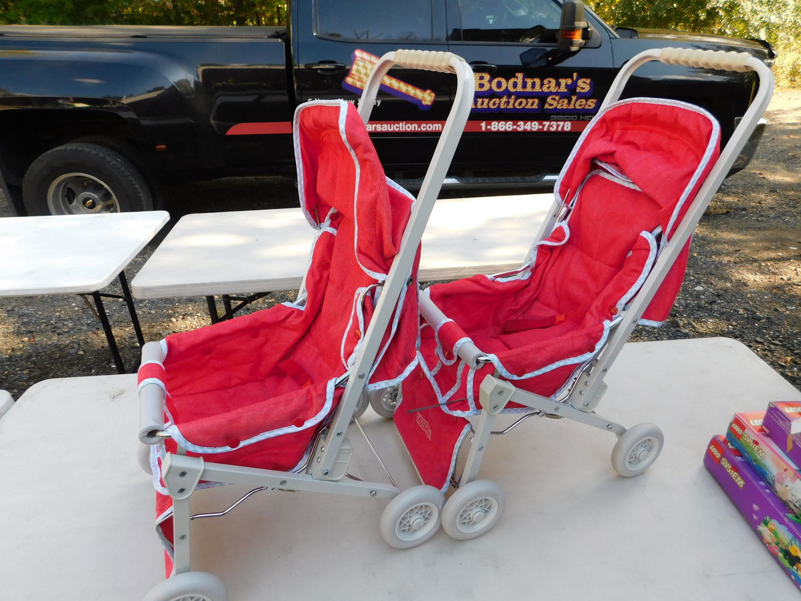 Lot of 2 American Girl Strollers: Lot of 2 American Girl Strollers. You are bidding at a live sale. Please read the terms and conditions. This sale will be broadcast live on sale day with full descriptions of each lot being sold, as w