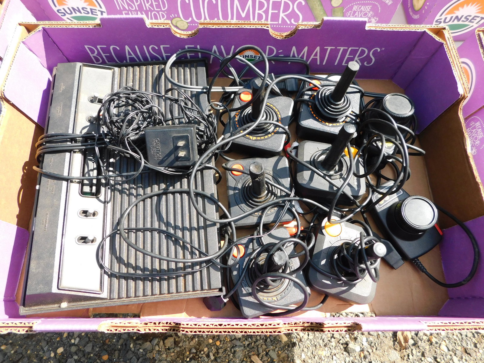 Box Lot with Atari and Joysticks: Box Lot with Atari and Joysticks. You are bidding at a live sale. Please read the terms and conditions. This sale will be broadcast live on sale day with full descriptions of each lot being sold, as w
