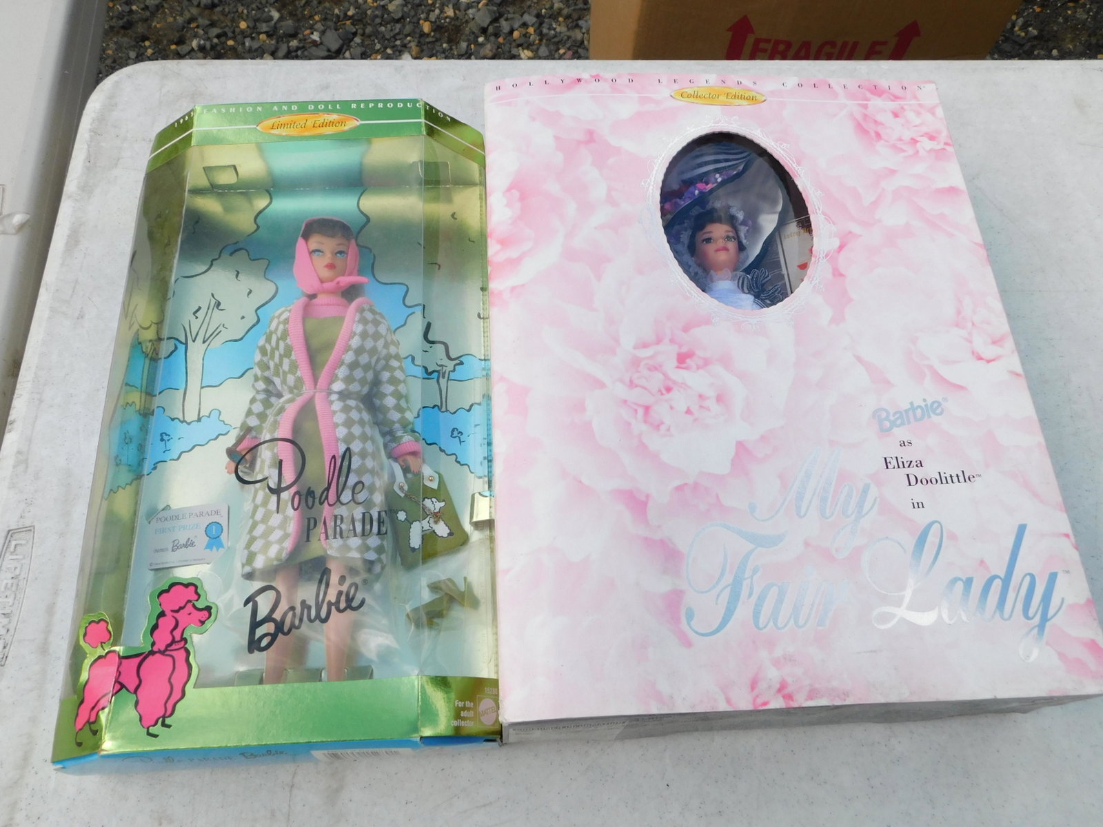 Lot of 2 Barbie's: Lot of 2 Barbie's including Poodle Parade and Eliza Doolittle. You are bidding at a live sale. Please read the terms and conditions. This sale will be broadcast live on sale day with full descriptions