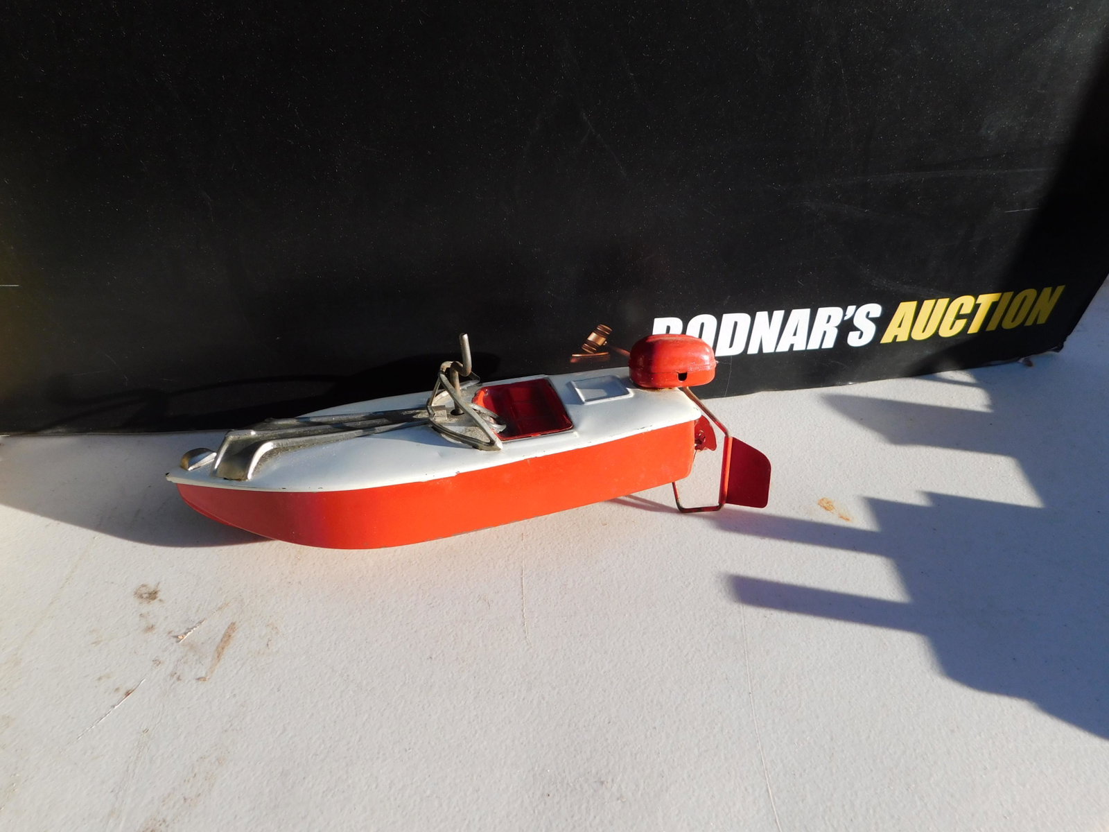 Tin Wind-Up Speedboat: Tin Wind-Up Speedboat. In working order. You are bidding at a live sale. Please read the terms and conditions. This sale will be broadcast live on sale day with full descriptions of each lot being sol