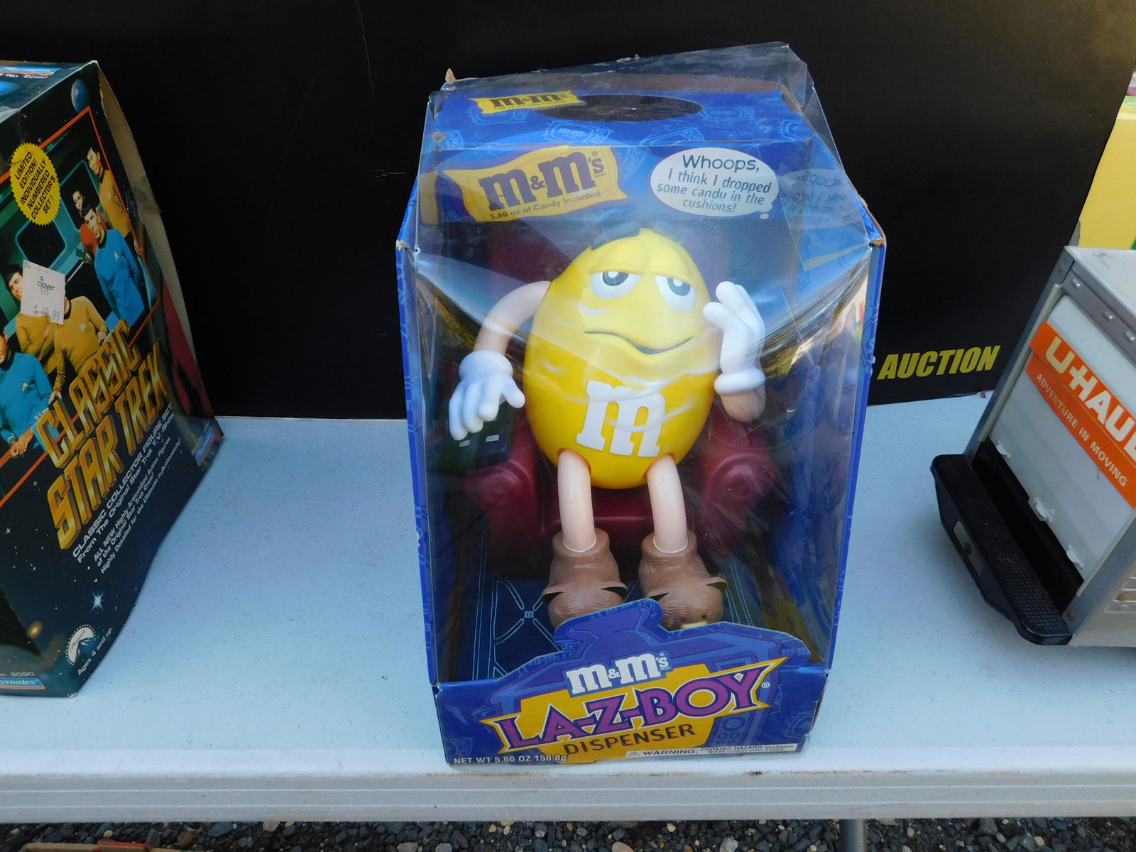 M&M's Lazy Boy Dispenser: M&M's Lazy Boy Dispenser in Box. You are bidding at a live sale. Please read the terms and conditions. This sale will be broadcast live on sale day with full descriptions of each lot being sold, as we