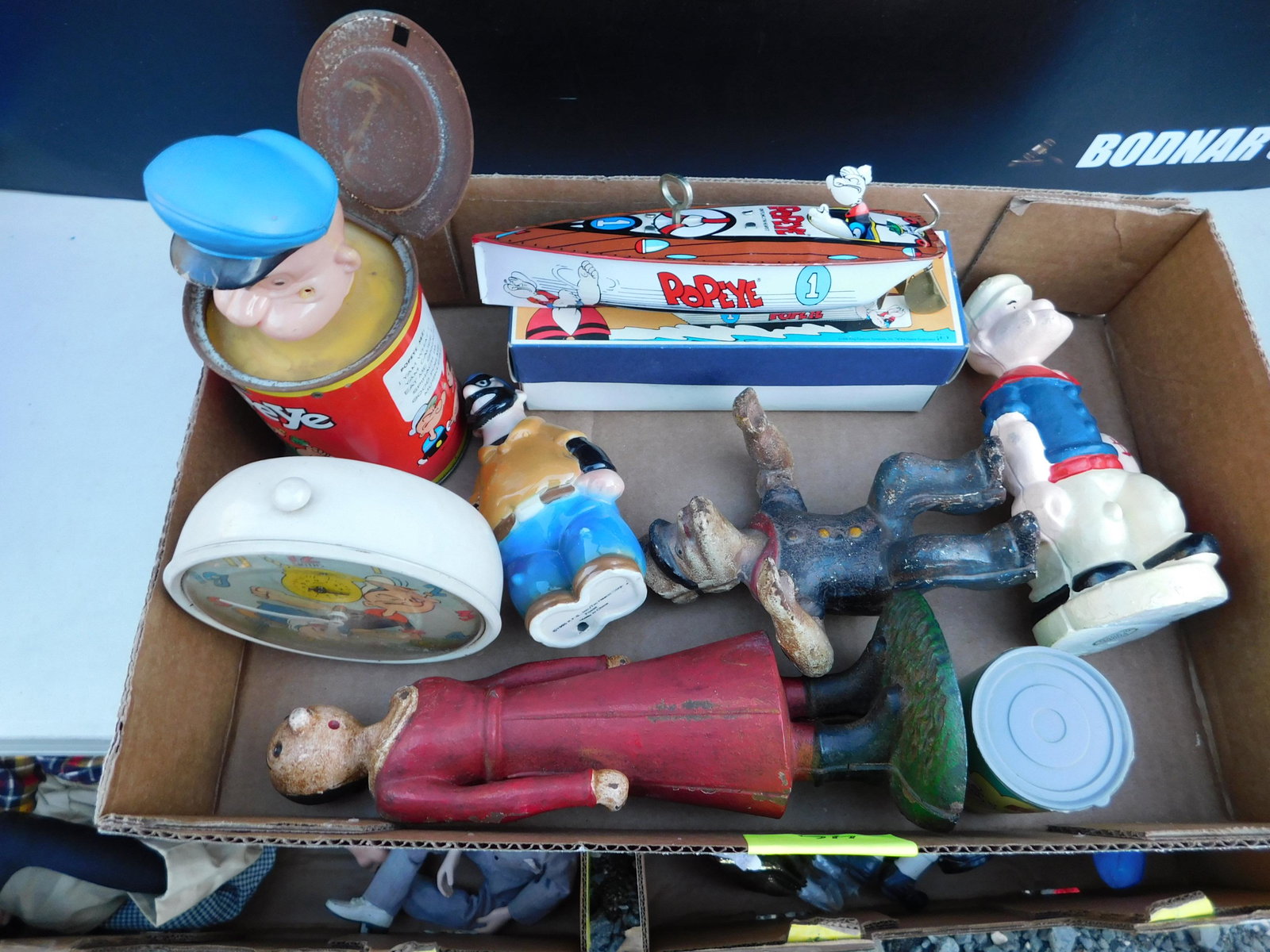 Box Lot of Popeye Toys: Box Lot of Popeye Toys. You are bidding at a live sale. Please read the terms and conditions. This sale will be broadcast live on sale day with full descriptions of each lot being sold, as well as vid