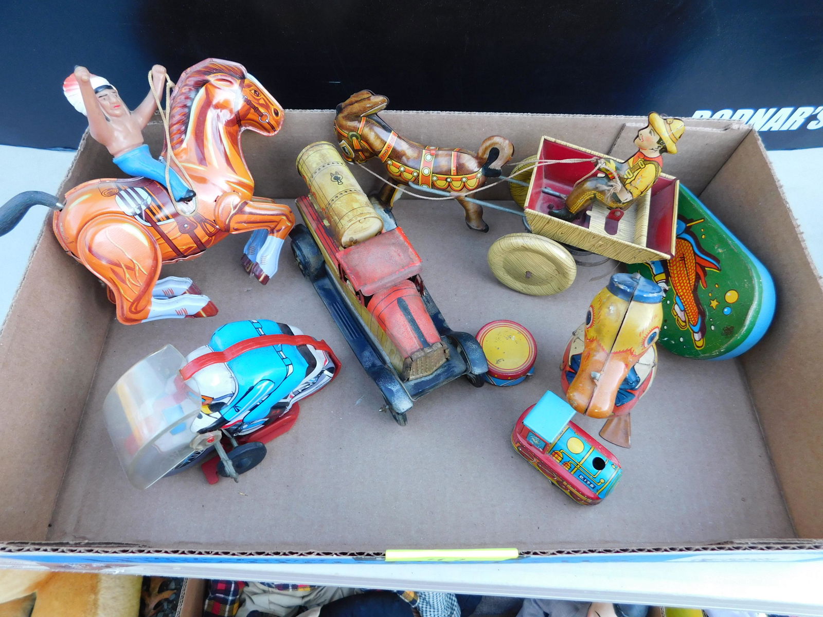 Box Lot of Vintage Tin Toys: Box Lot of Vintage Tin Toys. You are bidding at a live sale. Please read the terms and conditions. This sale will be broadcast live on sale day with full descriptions of each lot being sold, as well a