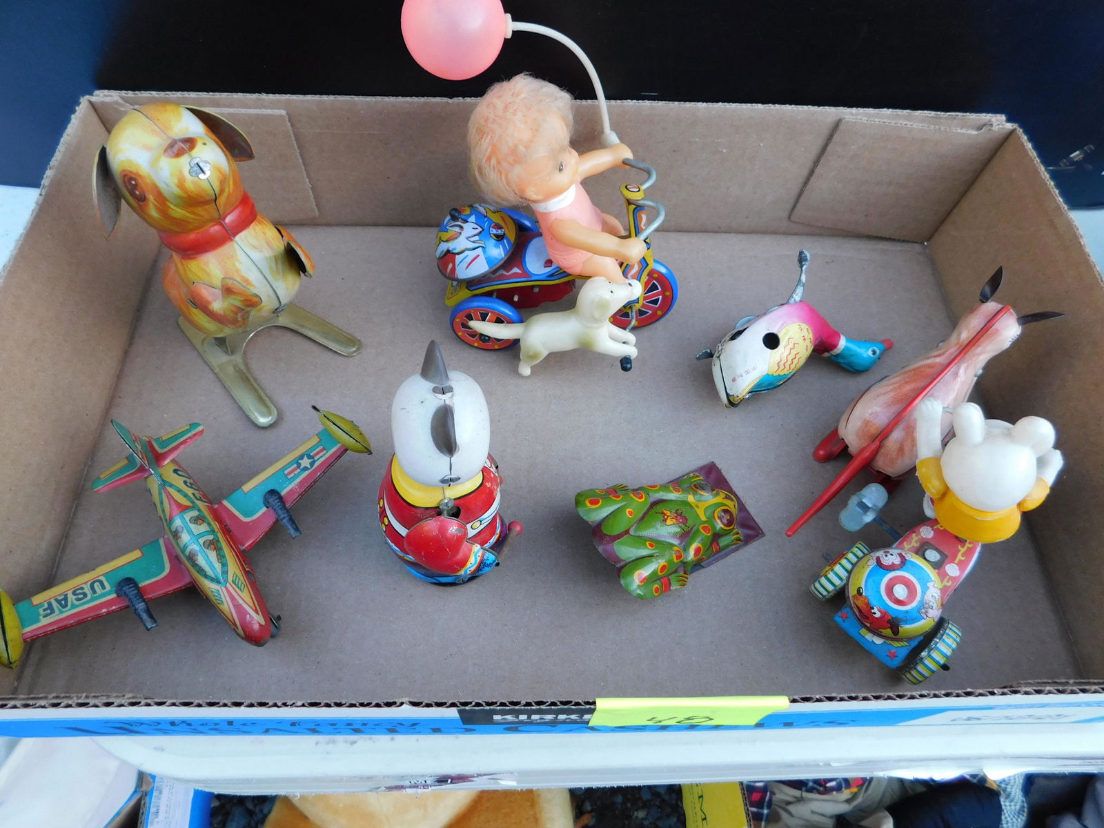 Box Lot of Vintage Tin Toys: Box Lot of Vintage Tin Toys. You are bidding at a live sale. Please read the terms and conditions. This sale will be broadcast live on sale day with full descriptions of each lot being sold, as well a