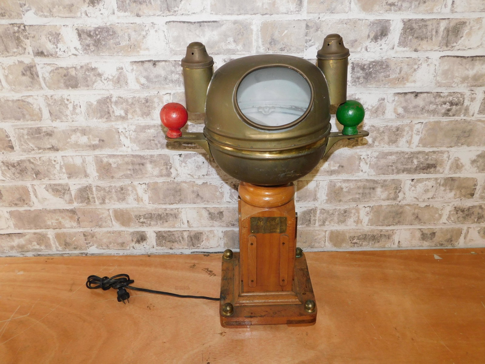 Ship's Compass Table Lamp: Ship's Compass Mounted as a Table Lamp. Measures 20.5" tall. You are bidding at a live sale. Please read the terms and conditions. This sale will be broadcast live on sale day with full descriptions o