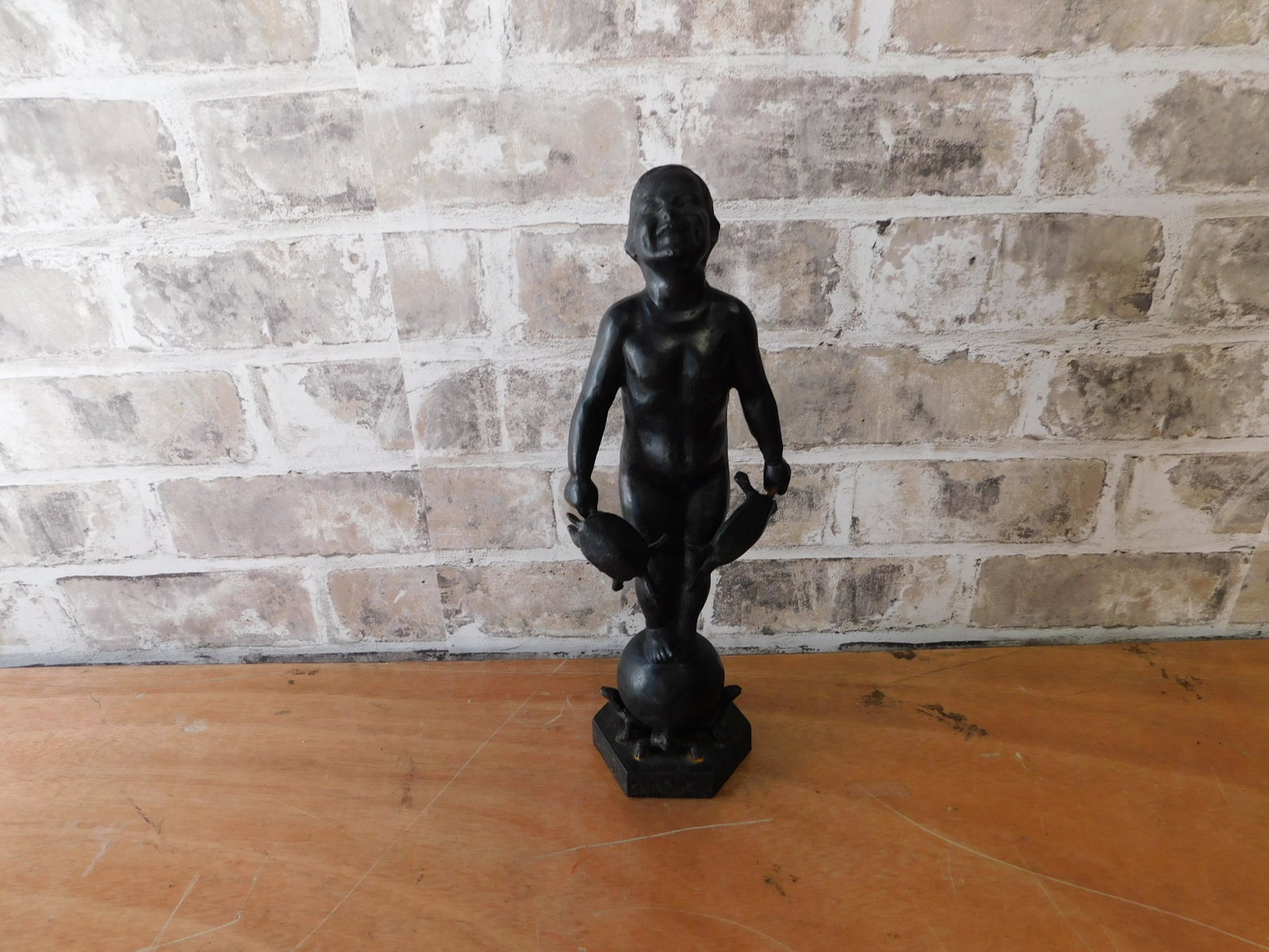 Cast Iron Statue of Man with Turtles: Cast Iron Statue of Man on Pedestal with Turtles. Measures 12" tall. You are bidding at a live sale. Please read the terms and conditions. This sale will be broadcast live on sale day with full descri