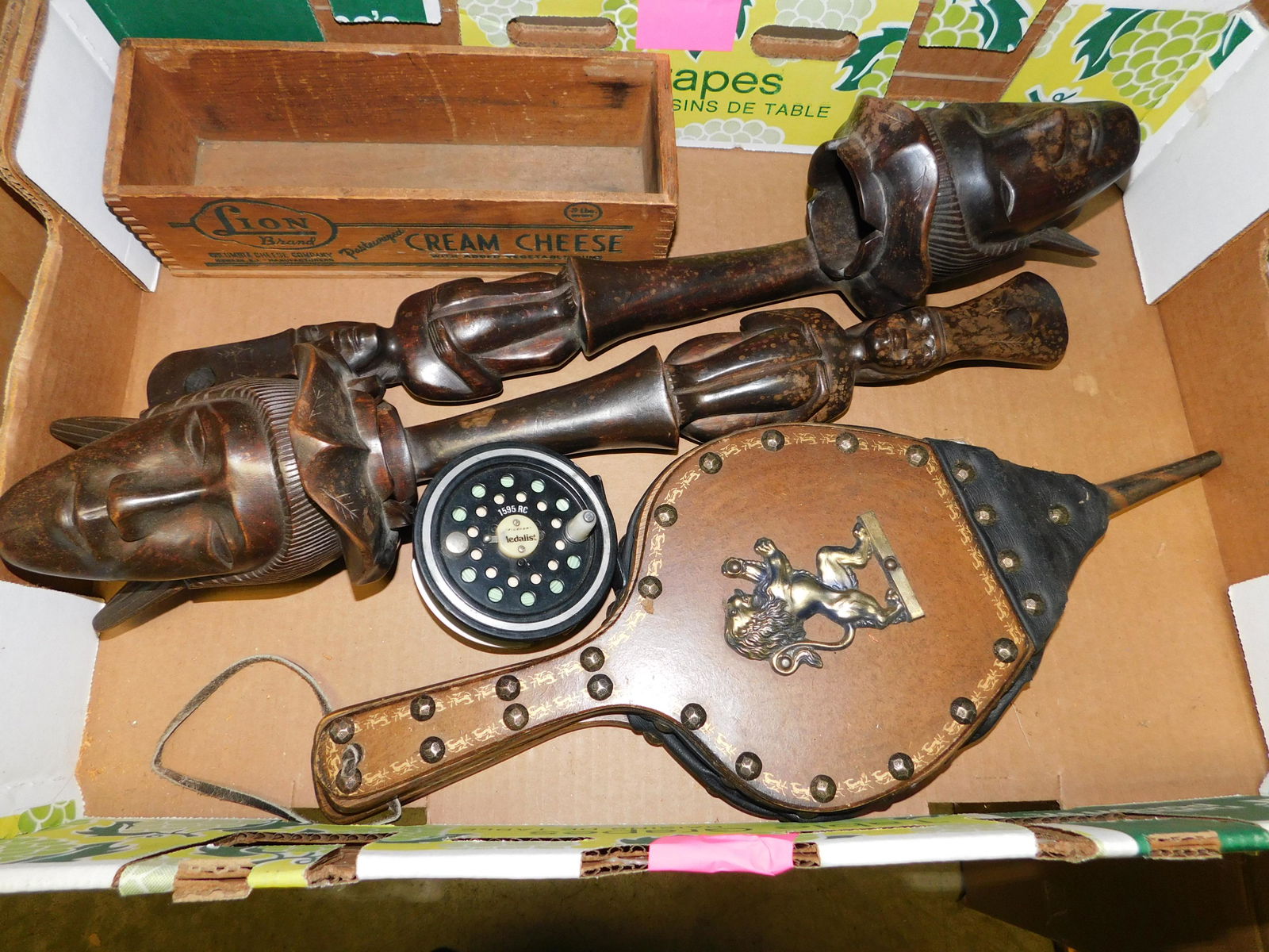 Box Lot with Fishing Reel and Wood Statues: Box Lot with Fishing Reel and Wood Statues. You are bidding at a live sale. Please read the terms and conditions. This sale will be broadcast live on sale day with full descriptions of each lot being