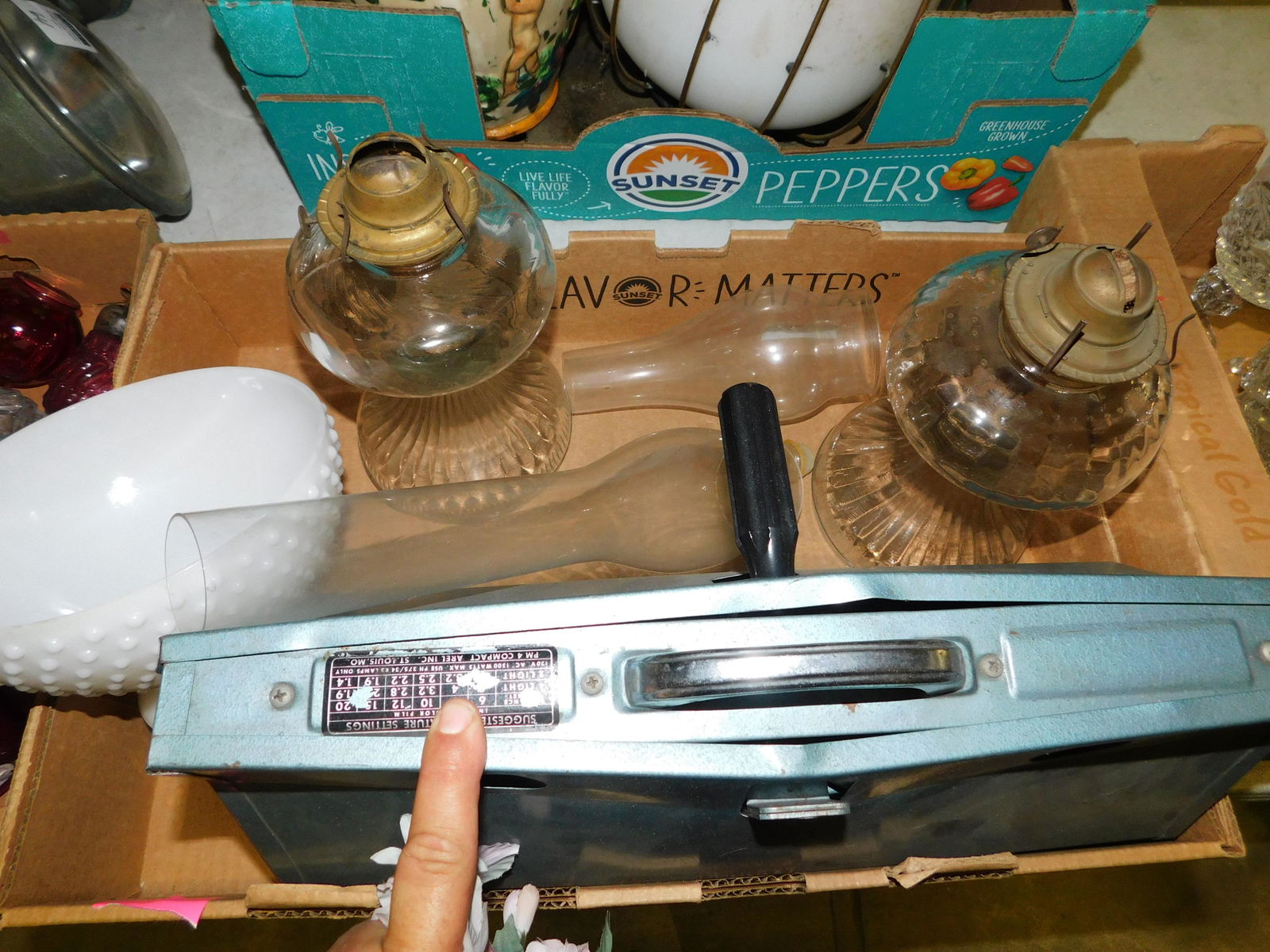 Box Lot of Oil Lamps: Box Lot with Oil Lamps. You are bidding at a live sale. Please read the terms and conditions. This sale will be broadcast live on sale day with full descriptions of each lot being sold, as well as vid