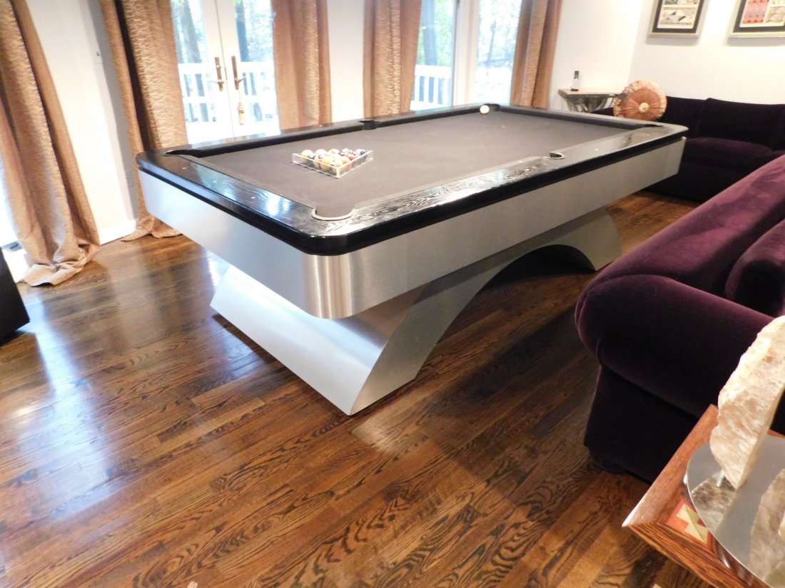 Art Deco/ Mid-Century style Pool Table: Art Deco/ Mid-Century style Pool Table, wood with metal overlay, is wired to light up underneath. Purchased at the D & D Building for over $10,000.00. Measures 102.5 inches long by 59 inches wide in e
