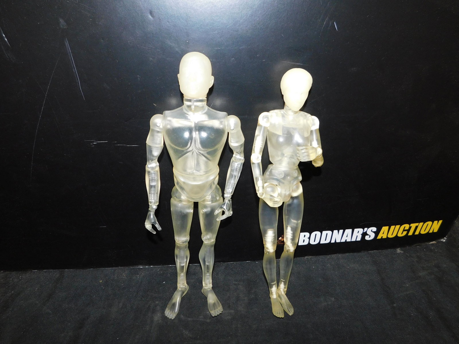 Lot of 2 Clear G.I. Joe and G.I. Jane Figures: Lot of 2 G.I. Joe and G.I. Jane Figures. Marked 1997 on G.I. Jane and 2003 on G.I. Joe. Does not have any accessories. You are bidding at a live sale, please read the terms and conditions. We are offe