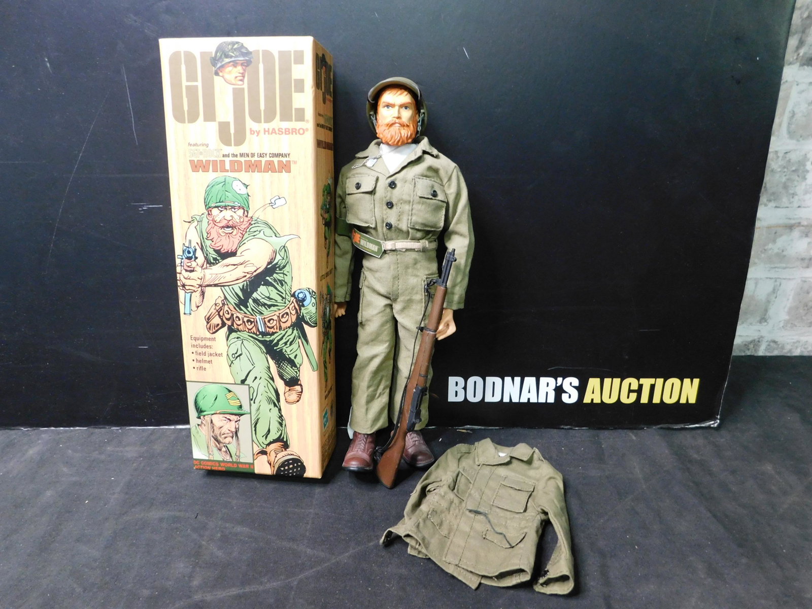 GI Joe Wildman Figure in Box: GI Joe 12" Figure featuring Sgt. Rock and Easy Company Wildman. Hasbro/DC Comics 2002. Comes in box. You are bidding at a live sale, please read the terms and conditions. We are offering contact-less 