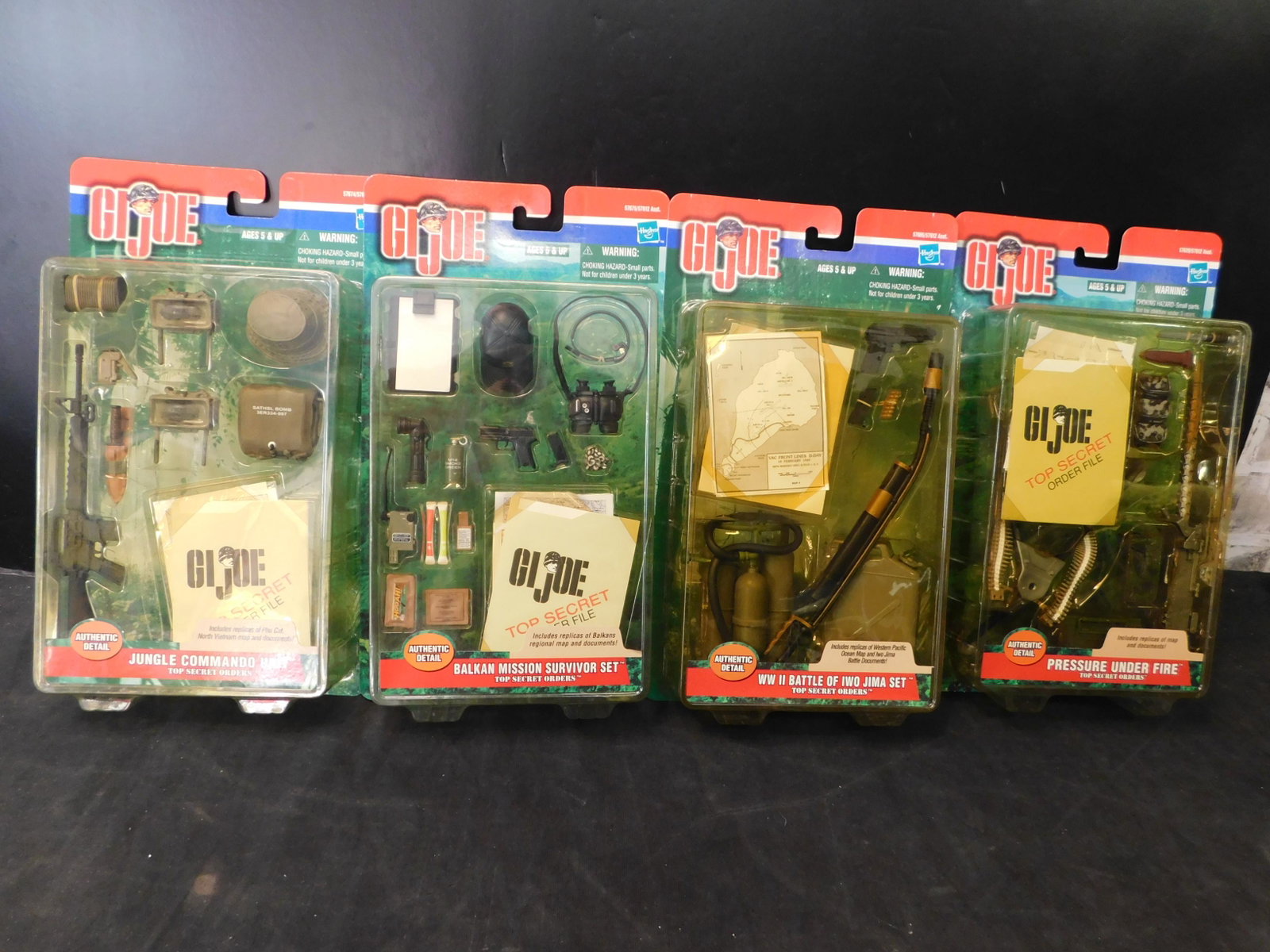 Lot of 4 GI Joe Accessories in Package: Lot of 4 GI Joe Accessories in Package. Included in this lot are Jungle Commando Unit, Balkan Mission Survivor Set, WWII Battle of Iwo Jima Set, and Pressure Under Fire. Hasbro 2000. You are bidding a