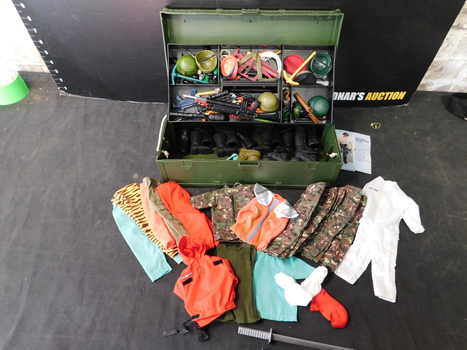 GI Joe Footlocker with Clothing/Weapons: GI Joe Footlocker filled with Clothing/Weapons. You are bidding at a live sale, please read the terms and conditions. We are offering contact-less pick ups at our South Brunswick location by APPOINTME