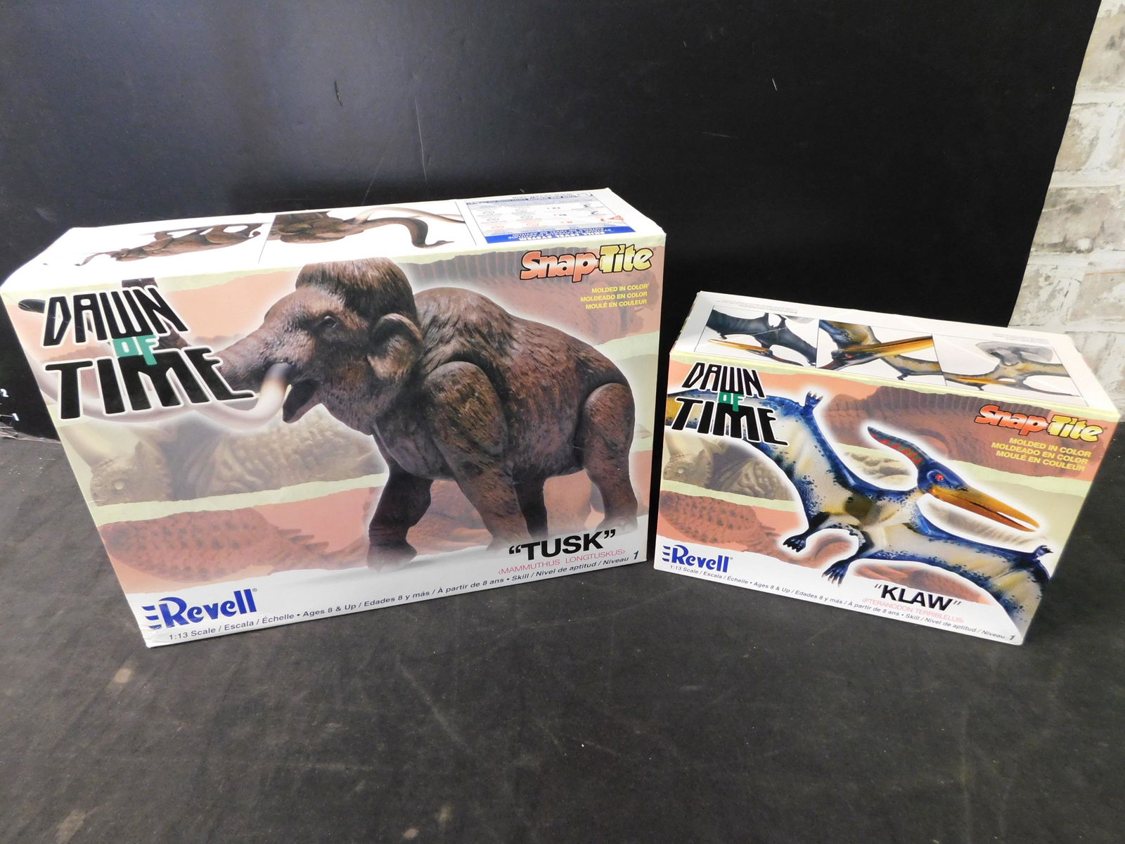 Lot of 2 Dawn of Time Dinosaur Model Kits - "Tusk" and: Lot of 2 Revell Dawn of Time Model Kits. Included are "Tusk" and "Klaw". All from private collector who disclosed to us that he just took off the factory seal to look at them and to the best of our kn