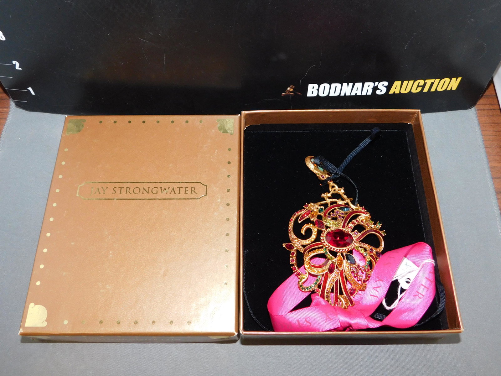Jay Strongwater 2010 Annual Ornament: Jay Strongwater 2010 annual ornament. It's gold tone & crystal ornament. Measures 5" long. You are bidding at a live sale, please read the terms and conditions. We are offering contact-less pick ups a