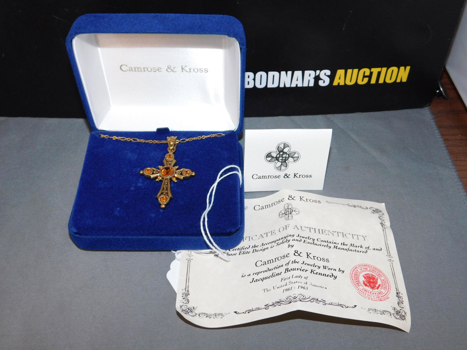 Camrose & Kross Cross Necklace: Camrose & Kross gold tone & crystal cross. Measures 20". Signed on the back. You are bidding at a live sale, please read the terms and conditions. We are offering contact-less pick ups at our South Br