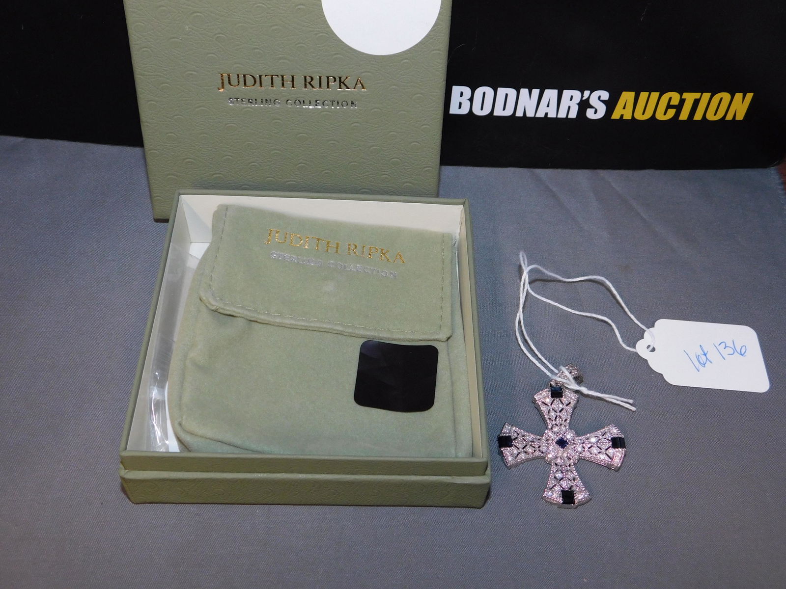 Judith Ripka Sterling Sapphire Cross Enhancer: Judith Ripka sterling silver, blue sapphire & diamonique cross enhancer. Measures 2" tall. Marked on the back. You are bidding at a live sale, please read the terms and conditions. We are offering con