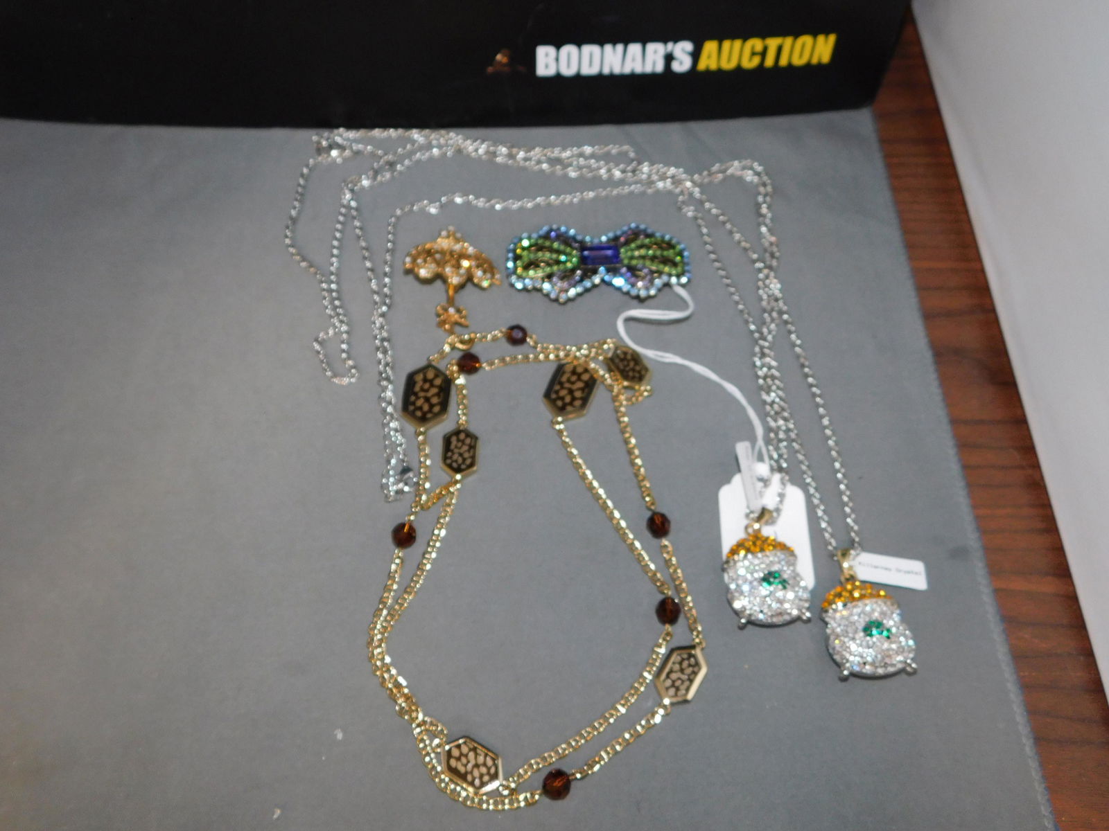 Lot of Assorted Costume Jewelry: Lot of assorted costume jewelry. Crystal Irish necklaces, gold tone station necklace and pins. You are bidding at a live sale, please read the terms and conditions. We are offering contact-less pick u