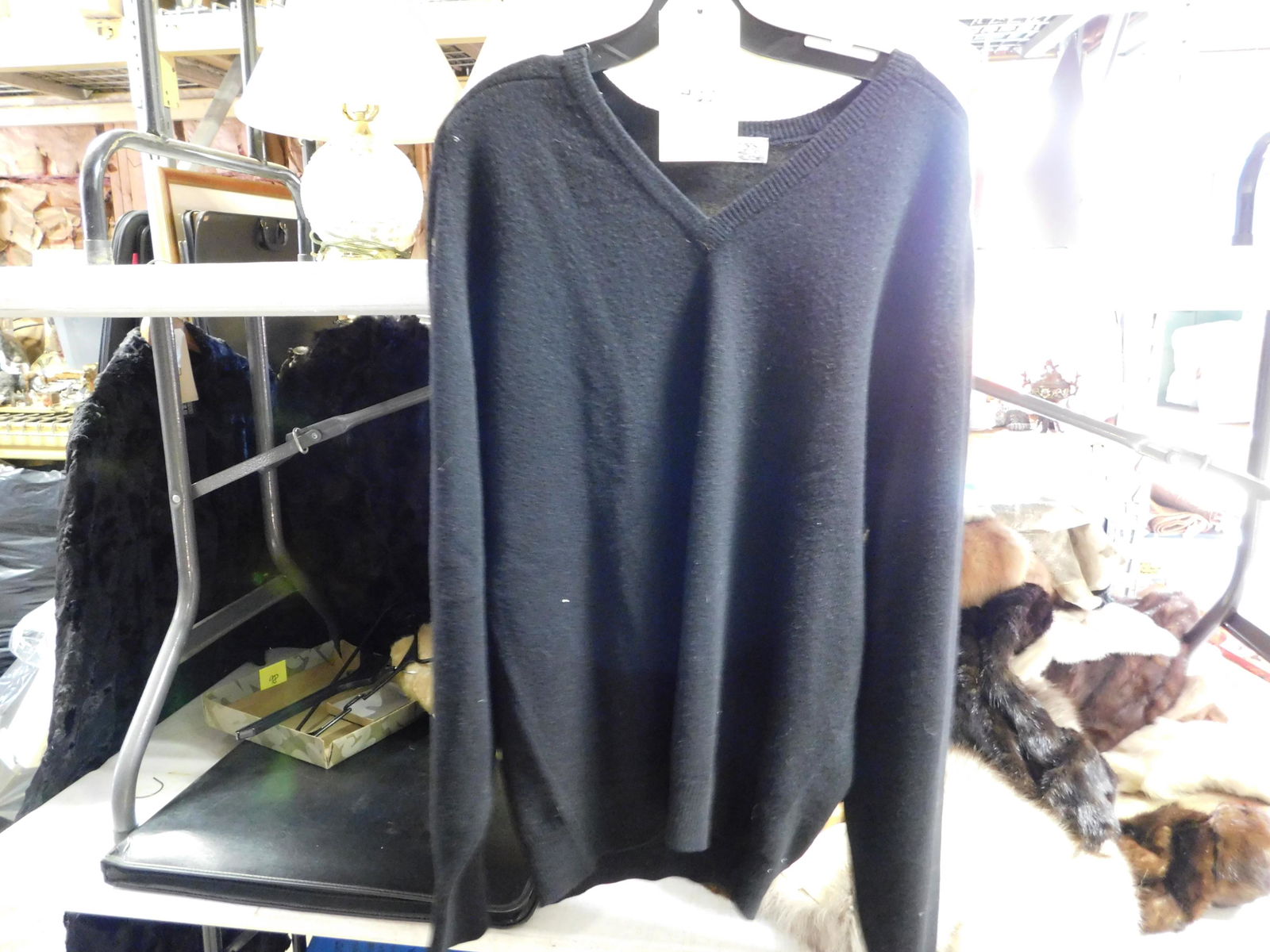Burberrys' Lambswool Sweater: Burberrys' Lambswool Black Sweater. Size 42. Some Pilling. We are offering contact-less pick ups at our South Brunswick location by APPOINTMENT ONLY on the Friday, Saturday, Monday and Tuesday immedia
