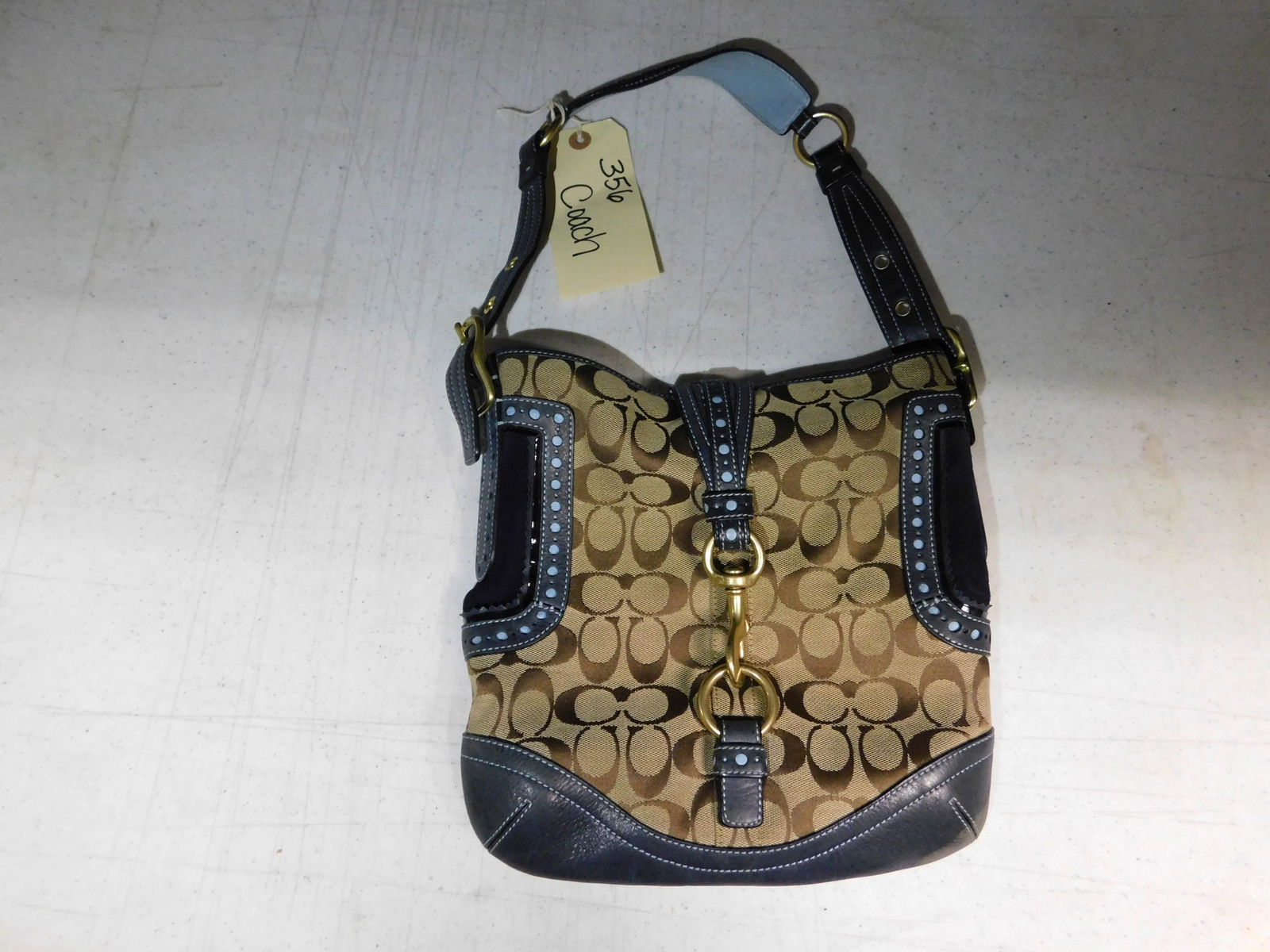 Coach Bag with Navy and Leather Trim: Coach Monogram Bag with Navy and Leather Trim. We are offering contact-less pick ups at our South Brunswick location by APPOINTMENT ONLY on the Friday, Saturday, Monday and Tuesday immediately followi