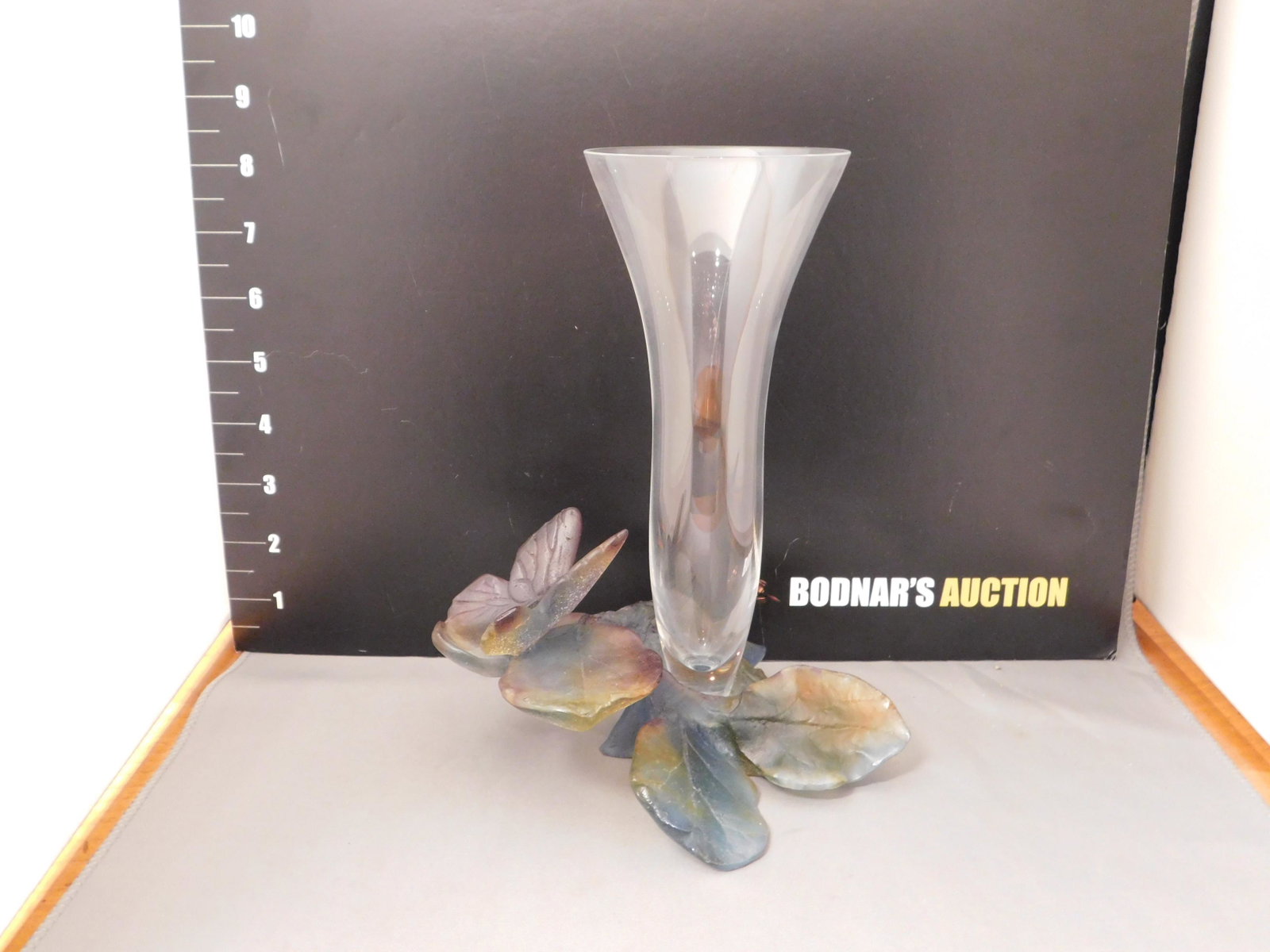Daum France Vase: Signed Daum France vase with a purple/green base with a butterfly in a matte glass. Measures approx. 8 1/2" tall x 5 1/2" wide. You are bidding at a live sale, please read the terms and conditions. We