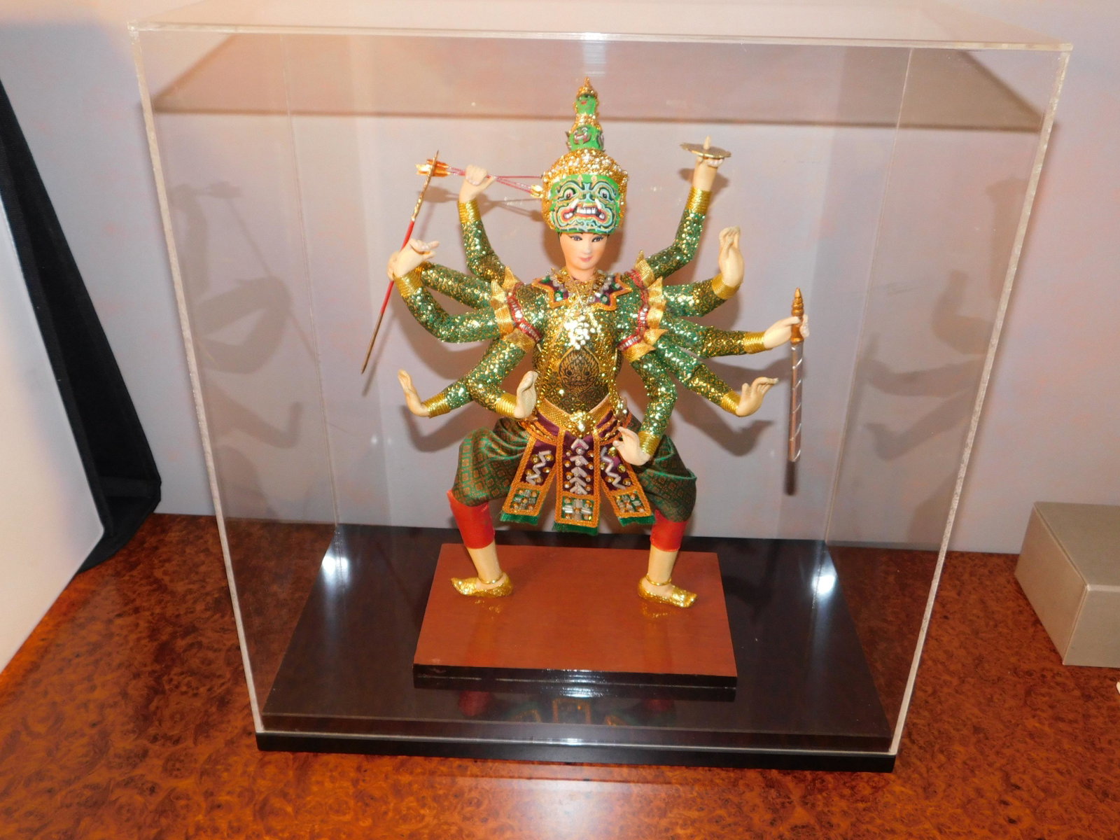 The Mighty Thosaganth: Bangkok Dolls #194 - the Mighty Thosaganth. Incased in a Lucite box. Measures approx. 16" tall x 15" wide. You are bidding at a live sale, please read the terms and conditions. We are offering contact