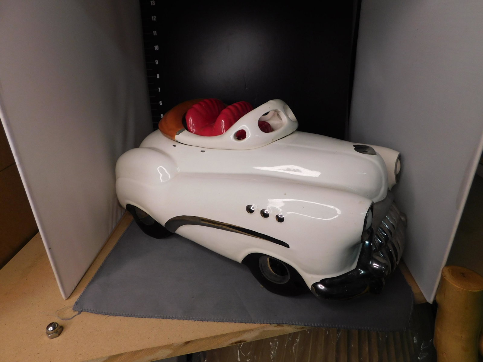 Convertible Car Cookie Jar: Signed convertible car cookie jar. Artist signature undetermined, it is slightly covered by the paint. 1987. Measures approx. 8" tall x 15" wide. You are bidding at a live sale, please read the terms 