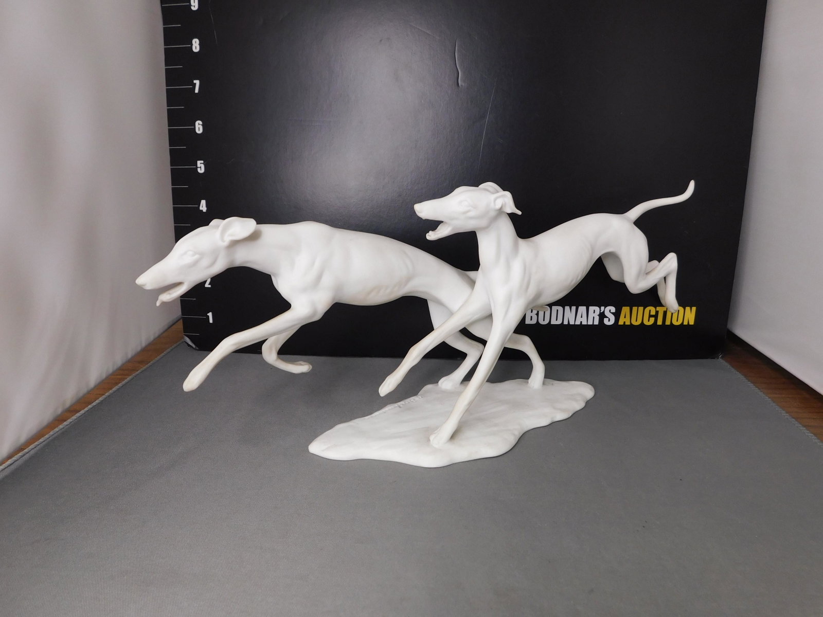 Kaiser Dog Figurine: Kaiser Dog Figurine. #408. Artist Signed in porcelain mold. Measures 5" tall x 12" long. You are bidding at a live sale, please read the terms and conditions. We are offering contact-less pick ups at 