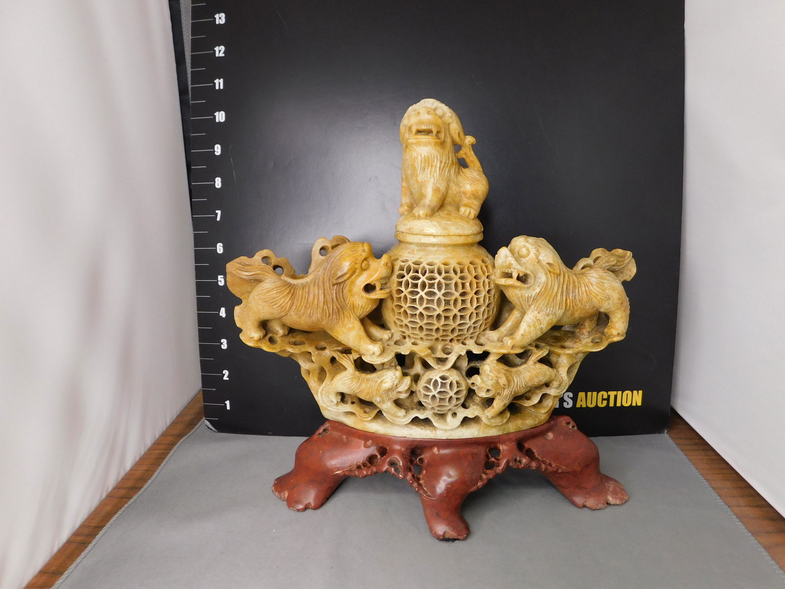 Carved Soapstone Oriental Foo Dog: Carved Soapstone Oriental Foo Dog Statue/Candle/Incense Burner. Base is also Soapstone. Measures 10" tall x 10" wide on base. You are bidding at a live sale, please read the terms and conditions. We a