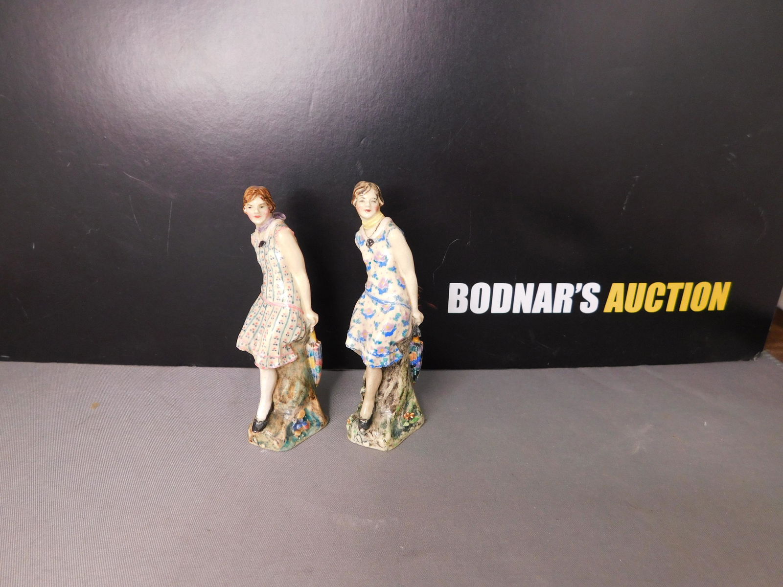 Lot of 2 Dulwich Pottery Figurines: Lot of 2 Dulwich Art Pottery Lady Figurines. Measures 3.25" tall. You are bidding at a live sale, please read the terms and conditions. We are offering contact-less pick ups at our South Brunswick loc