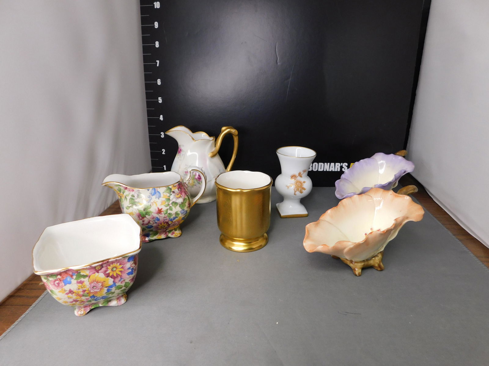 Group Lot of Quality Porcelain including Limoges: Group Lot of Quality Porcelain including a pair of floral pitchers, Piccard toothpick holder, Limoges bud vase, Chintz Pattern Royal Winton Creamer and sugar with minor flake, and Limoges Pitcher. Mea