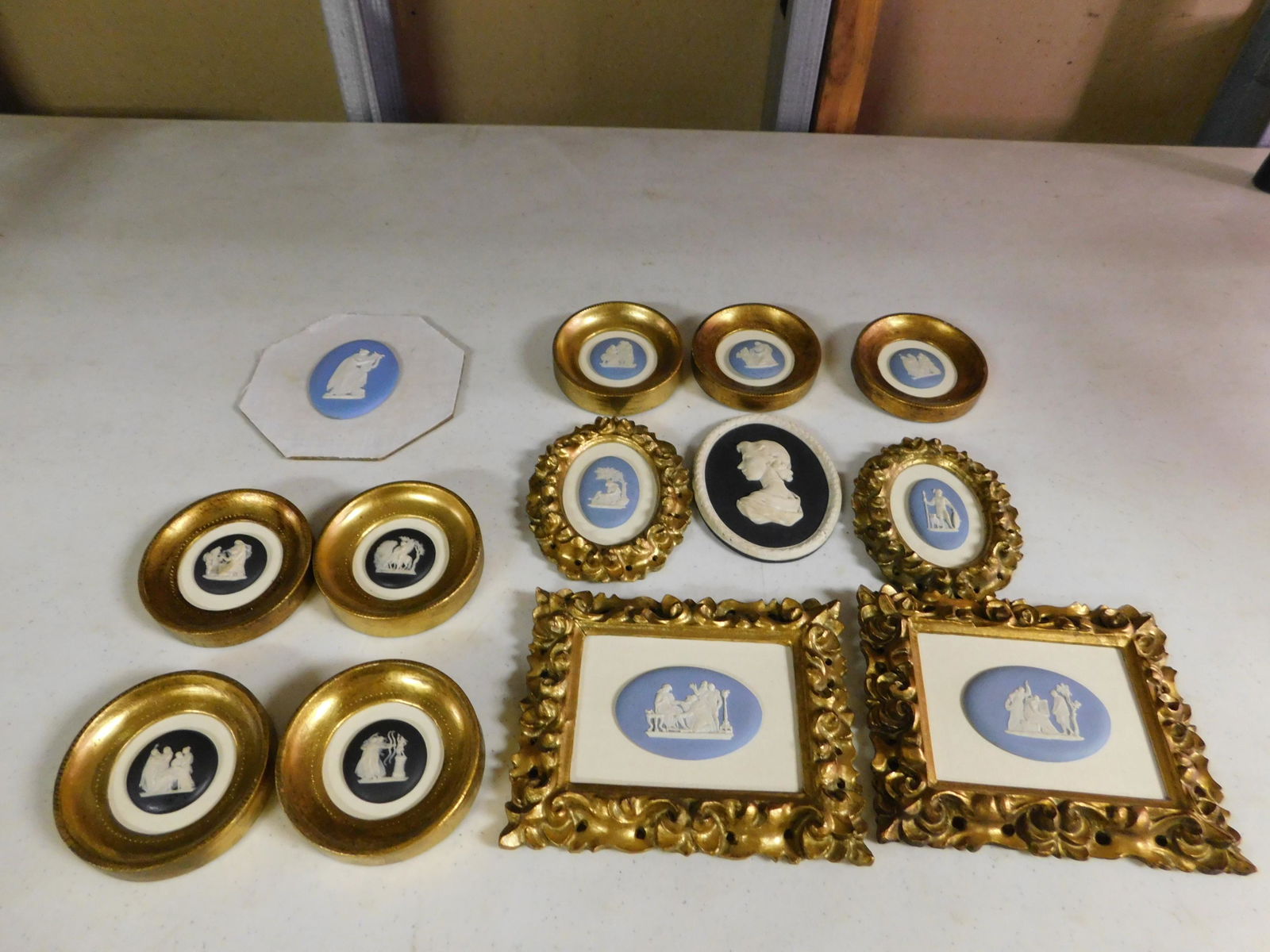 Lot of 13 Miniature Wedgewood Plaques: Lot of 13 Miniature - Mostly Framed - Wedgewood Black and Blue Jasper Plaques. Measures 3" x 2" - 5.5" x 5". You are bidding at a live sale, please read the terms and conditions. We are offering conta