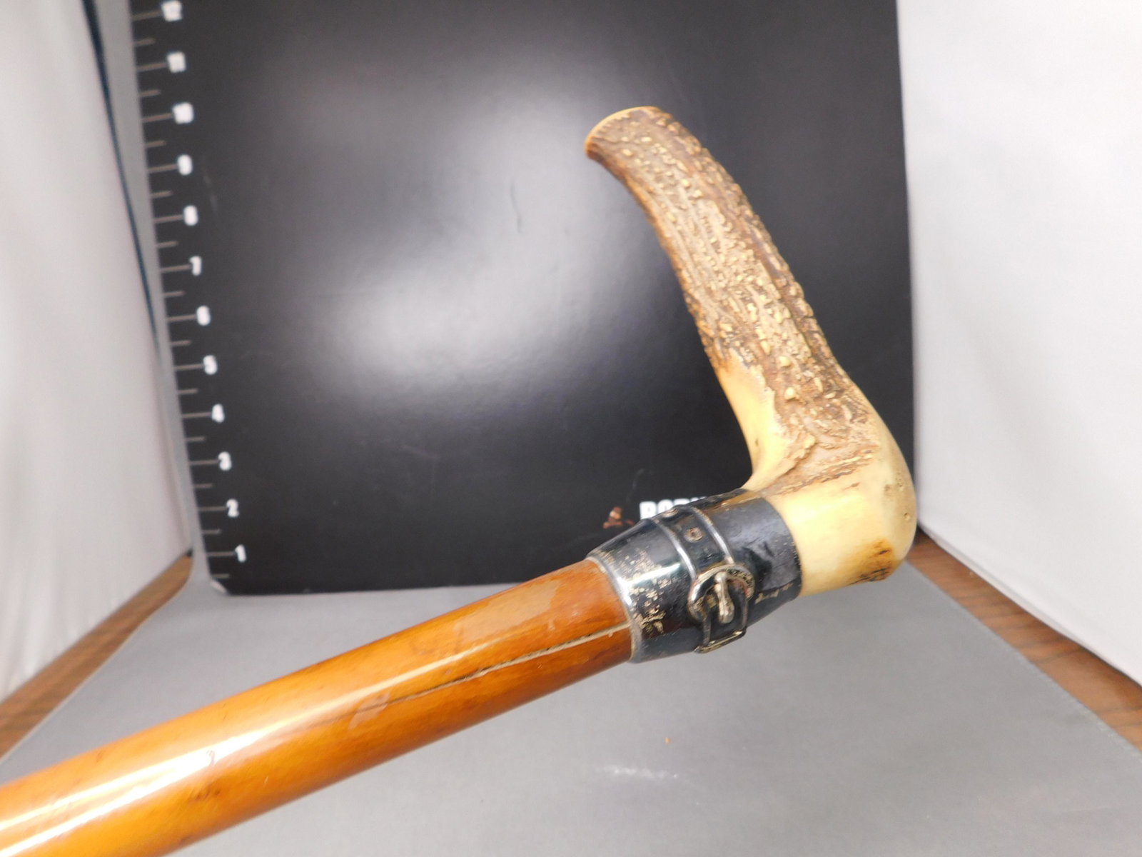 Vintage Walking Stick with Carved Stag Antler Handler: Vintage Walking Stick with Carved Stag Antler Handle and Sterling Barrel Banded. Measures 34" long. You are bidding at a live sale, please read the terms and conditions. We are offering contact-less p
