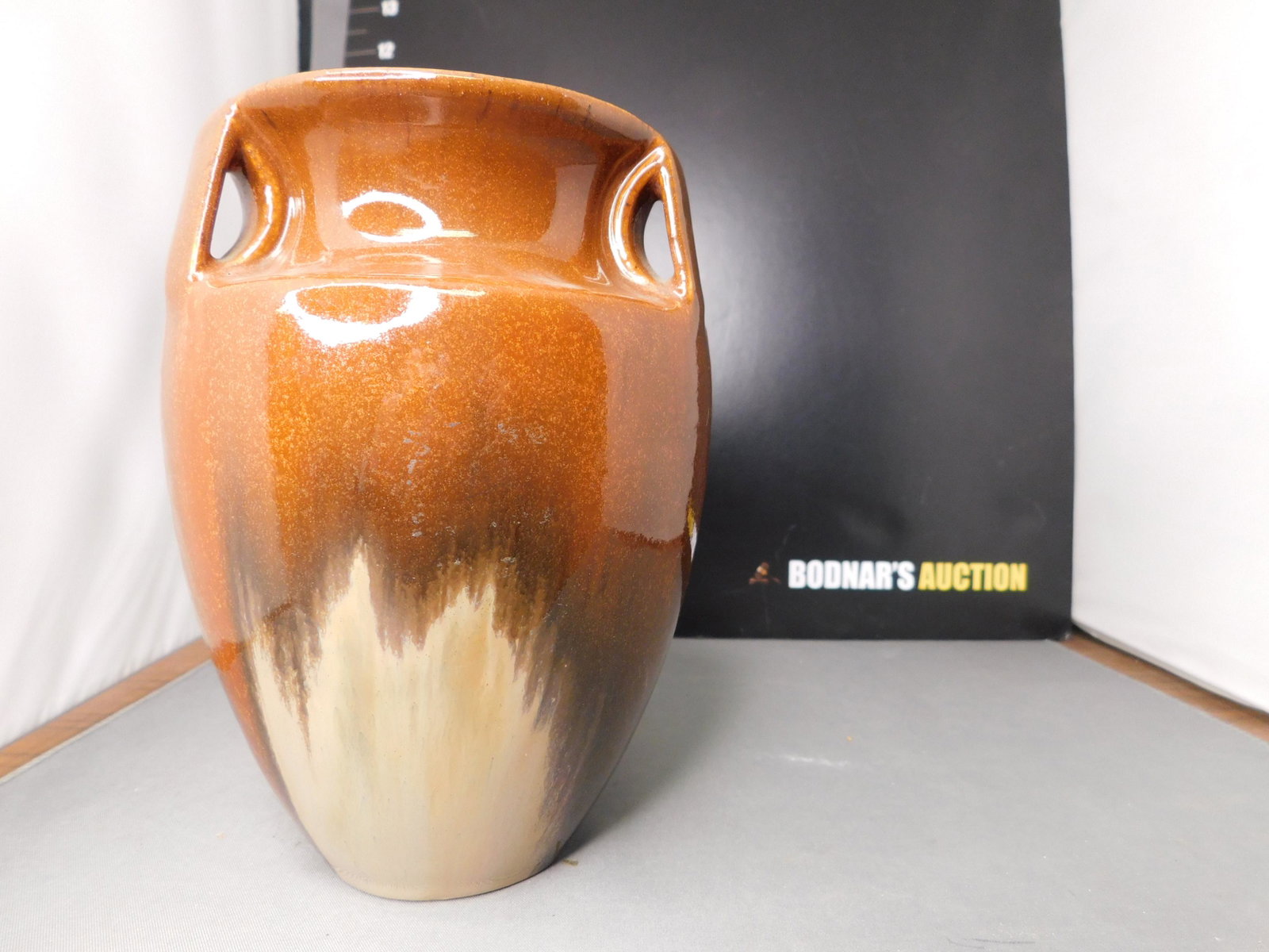 Fulper Pottery Vase: Fulper Pottery Brown Vase. 3 Handles. Measures 6.5" tall x 4" d. You are bidding at a live sale, please read the terms and conditions. We are offering contact-less pick ups at our South Brunswick loca
