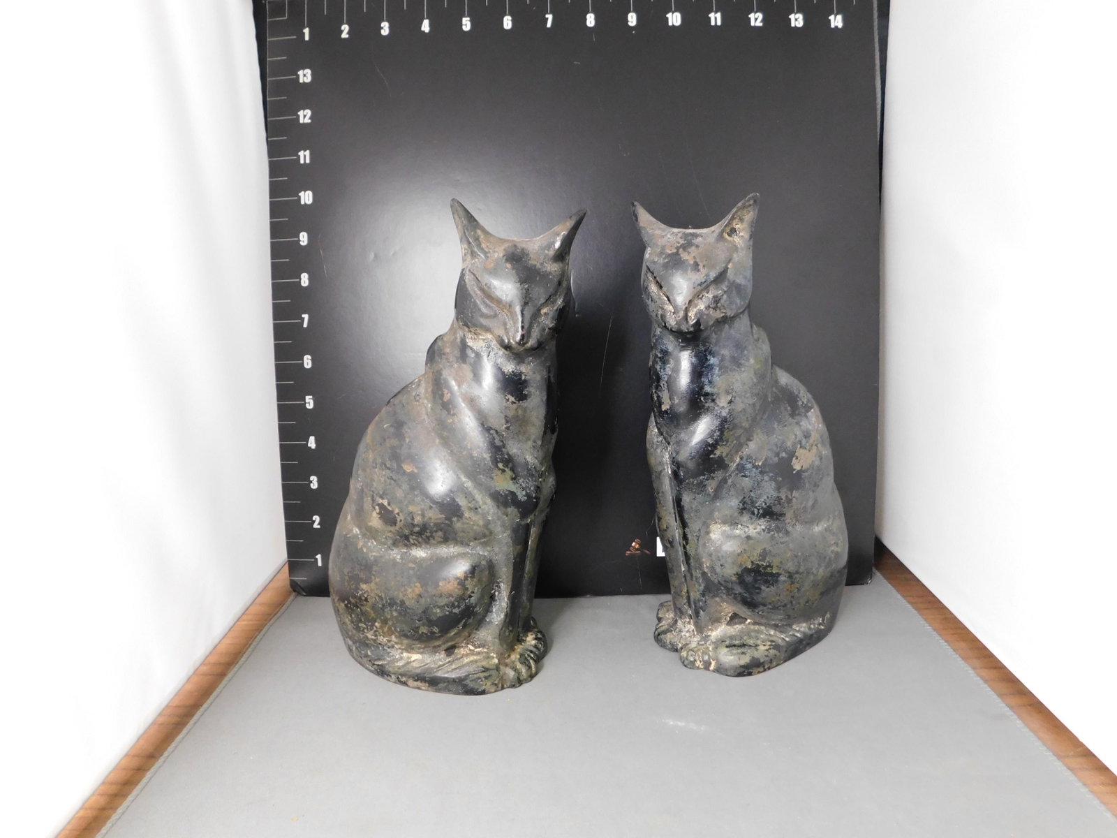 Pair of Art Deco Cast Iron Cat Figurines: Pair of Art Deco Cast Iron Cat Figurines. Measures 9.5" tall x 4.5" long. You are bidding at a live sale, please read the terms and conditions. We are offering contact-less pick ups at our South Bruns