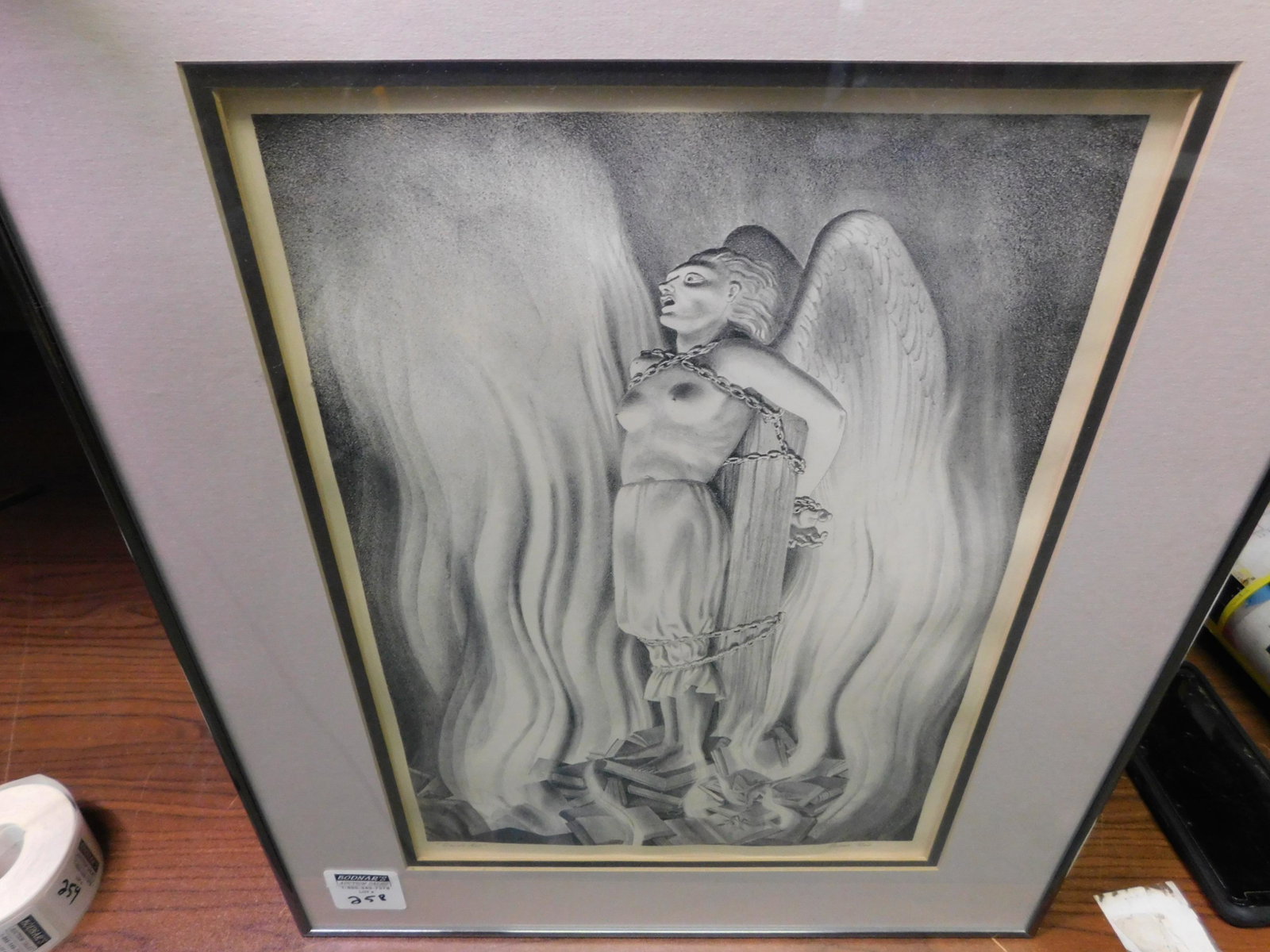 Art Deco Litho. Signed Rockwell Kent - Smith Act: Framed Art Deco Lithograph Signed Lower Right Rockwell Kent. Entitled Smith Act. Depicting an Angel Chained to books on fire. 1951. Image measures 15" tall x 10.5" wide. You are bidding at a live sale