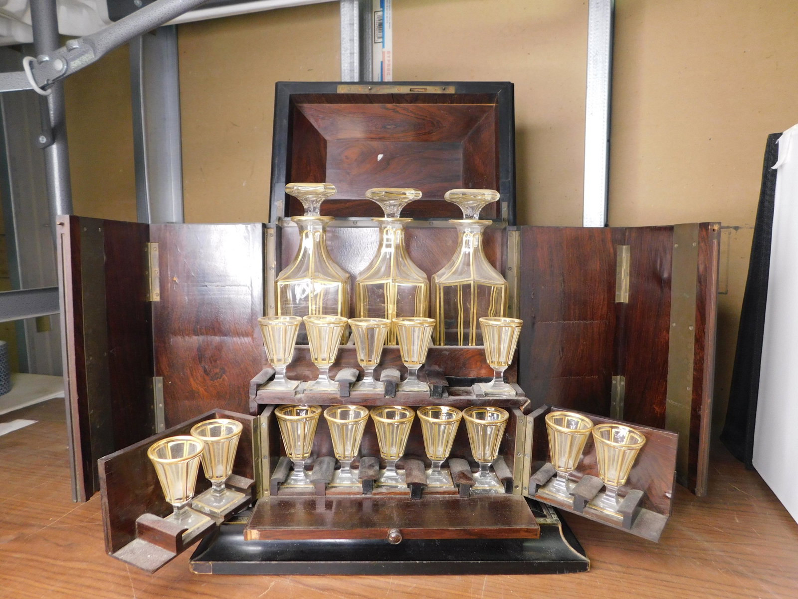 19th Century Inlaid Casket Box with Decanters and Shot: 19th Century Ornately Inlaid Casket Style Box with 3 Decanters and 15 Shot Glasses. Bottles are most likely Baccarat. In rough condition. You are bidding at a live sale, please read the terms and cond