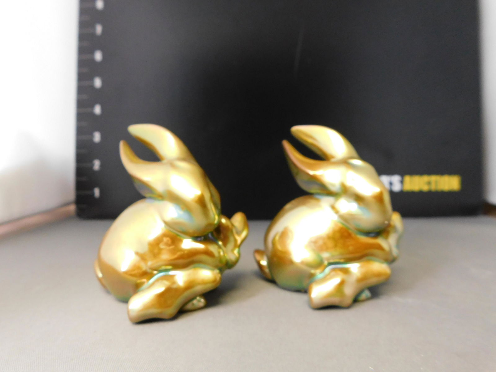 Pair of Zsolnay Bunnies: Pair of Zsolnay Eosin Bunnies. Measures 3.5" tall. You are bidding at a live sale, please read the terms and conditions. We are offering contact-less pick ups at our South Brunswick location by APPOIN