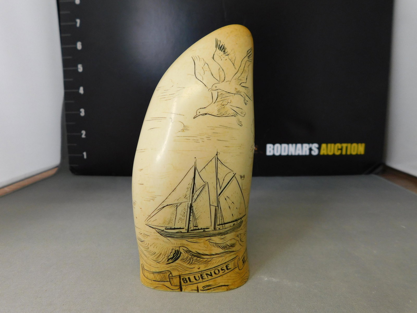 Souvenir Scrimshaw: Souvenir Scrimshaw. The Blue Nose II. Nova Scotia. Comes in a box with tag that says Made in Britain. Measures 4.25" tall. You are bidding at a live sale, please read the terms and conditions. We are 