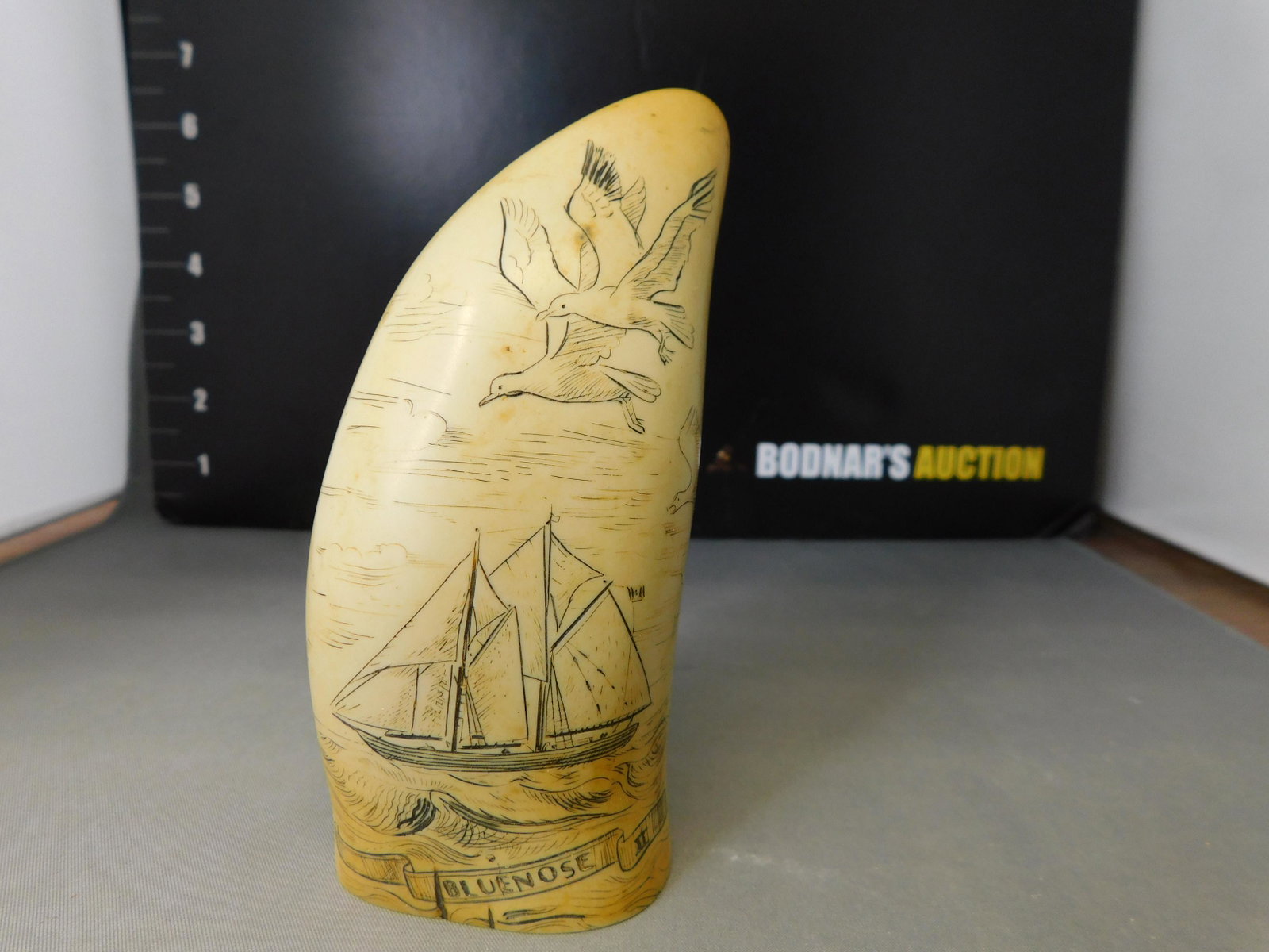 Souvenir Scrimshaw: Souvenir Scrimshaw. The Blue Nose II. Nova Scotia. Comes in a box with tag that says Made in Britain. Measures 4.25" tall. You are bidding at a live sale, please read the terms and conditions. We are 