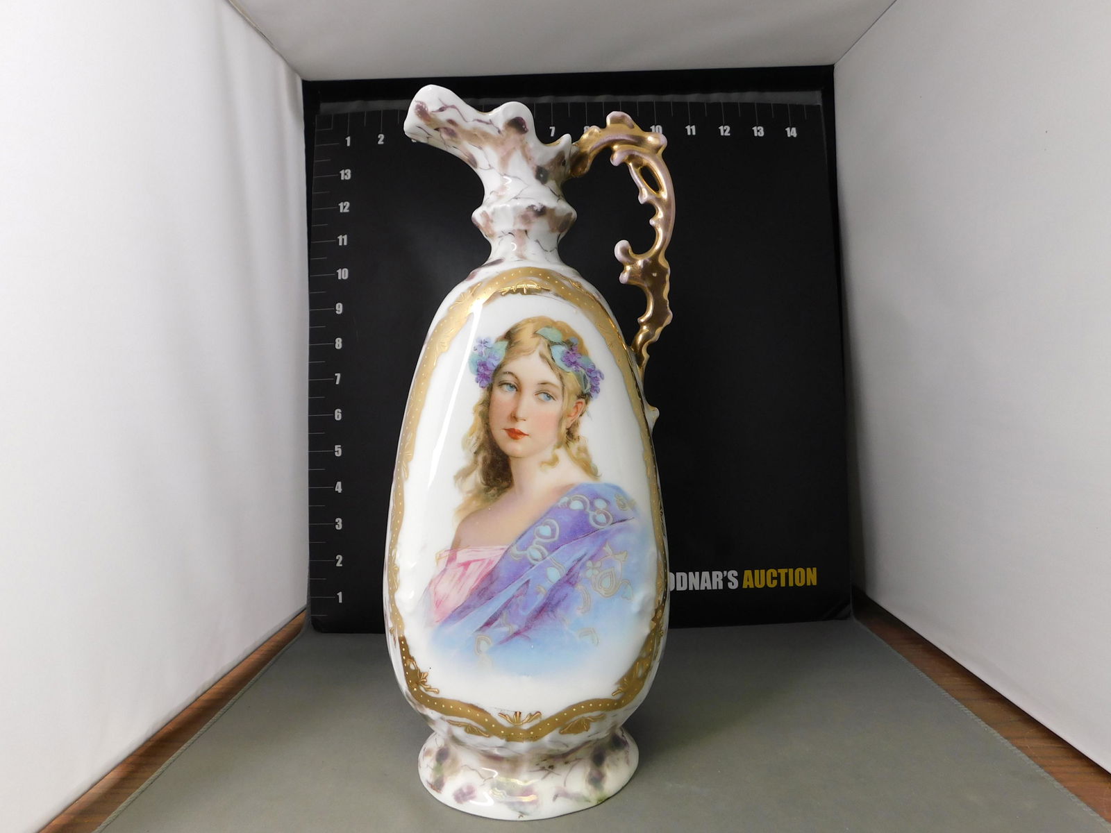 Victoria Carlsbad Pitcher: Victoria Carlsbad Transferware Pitcher with Young Woman. Some wear to gold handle. Measures 11" tall. You are bidding at a live sale, please read the terms and conditions. We are offering contact-less
