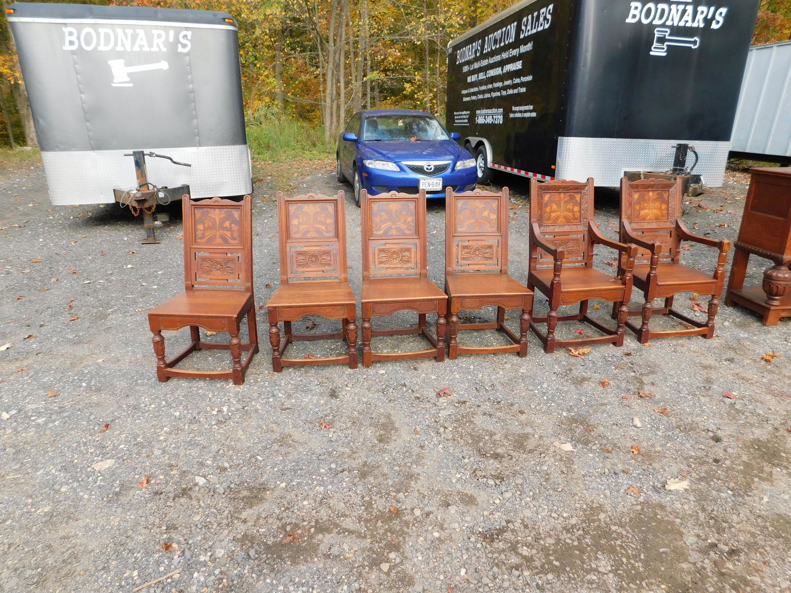 10-piece refractory dining room set: Ornate 10-piece refractory dining room set with unusual fancy inlaid flower designs. Set contains table with 6 chairs, server, sideboard and blind china. This sale will be broadcast live on sale day w