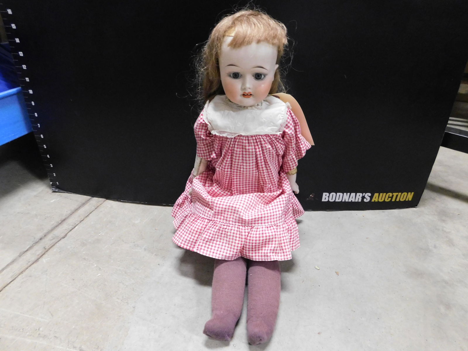 Antique Porcelain Head Doll: Antique Porcelain Head Doll. Marking Undetermined. Has Leather Body. Measures 23" tall. This sale will be broadcast live on sale day with full descriptions of each lot being sold, as well as video fee